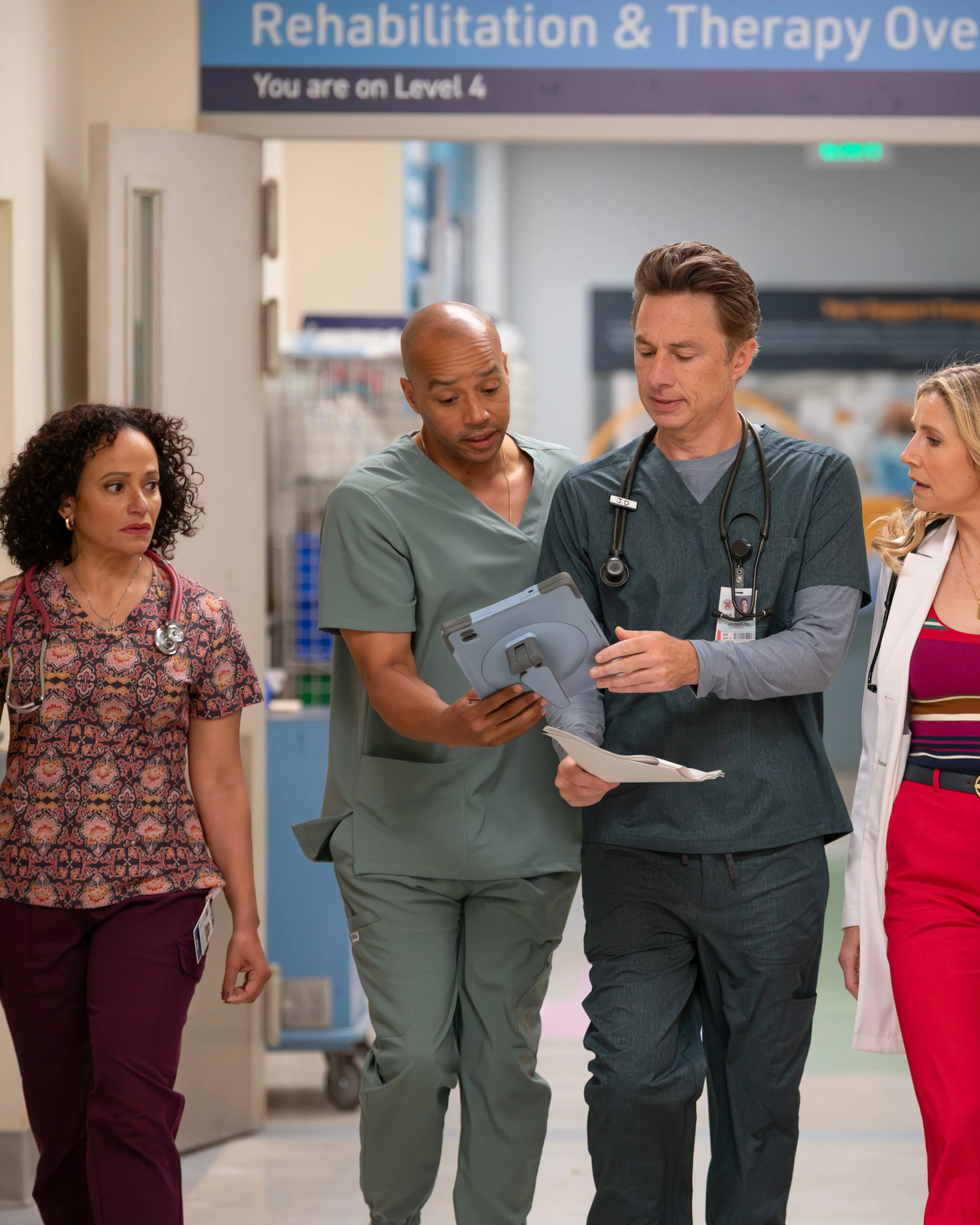 Ava Bunn as Dr. Sam Tosh walks with J.D., Turk and Elliot.