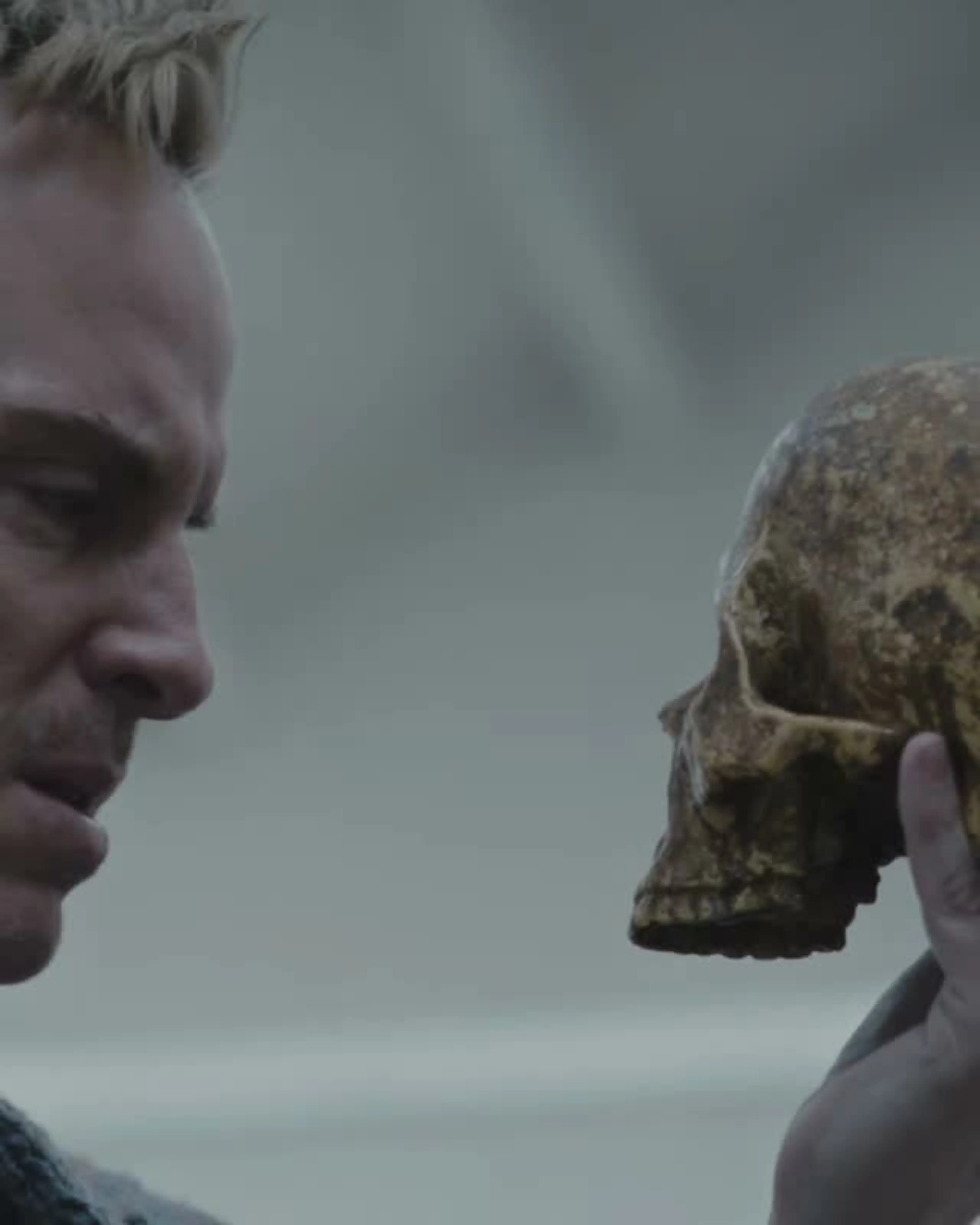 Andrew Scott as Ian Charleson holds a skull in a frame from the official Elsinore trailer.