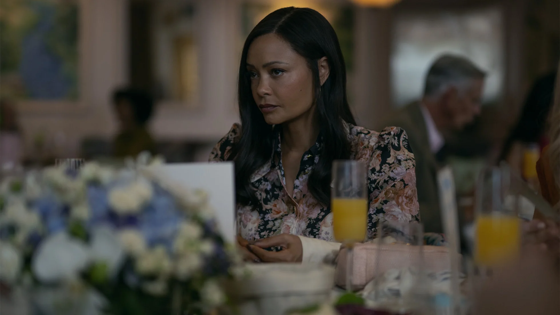 Thandiwe Newton sits at a table in The Wanted Man.