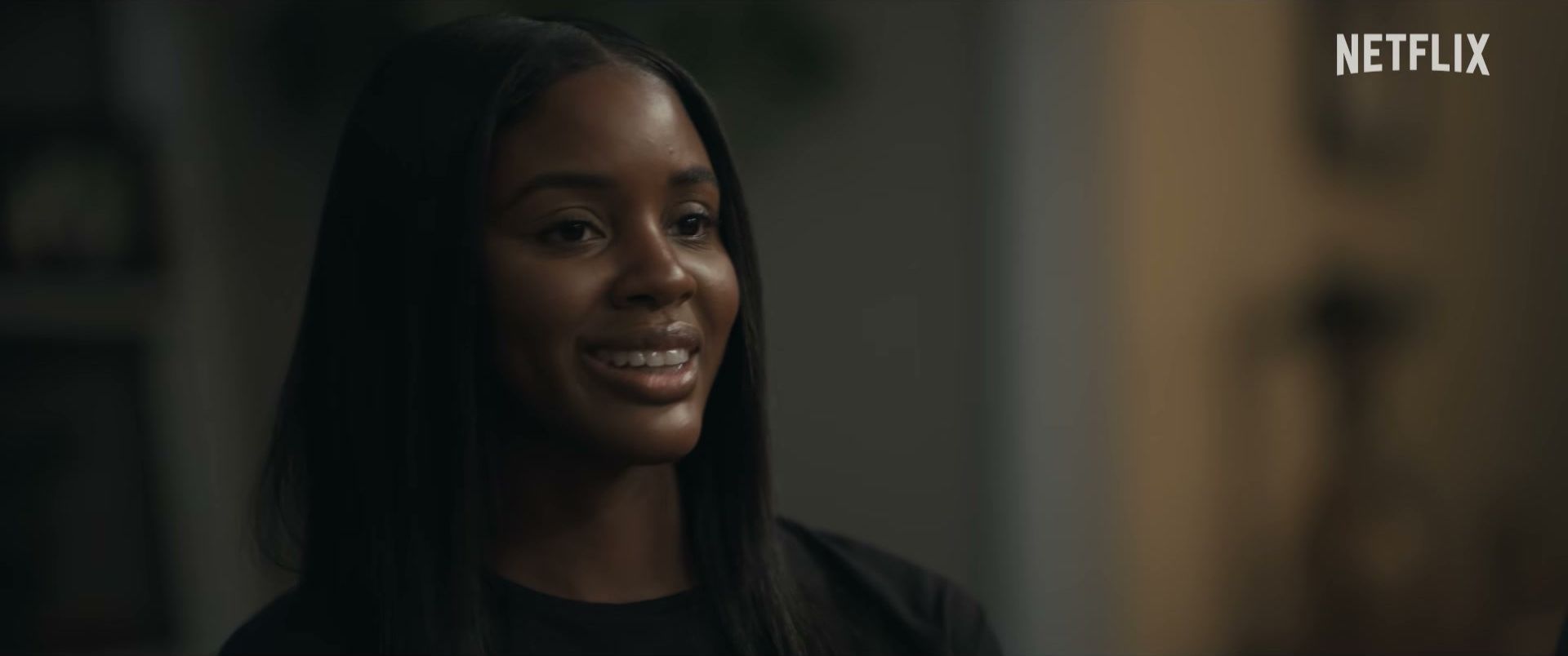 Naomi Baker looks toward someone during a conversation in Doing Life.
