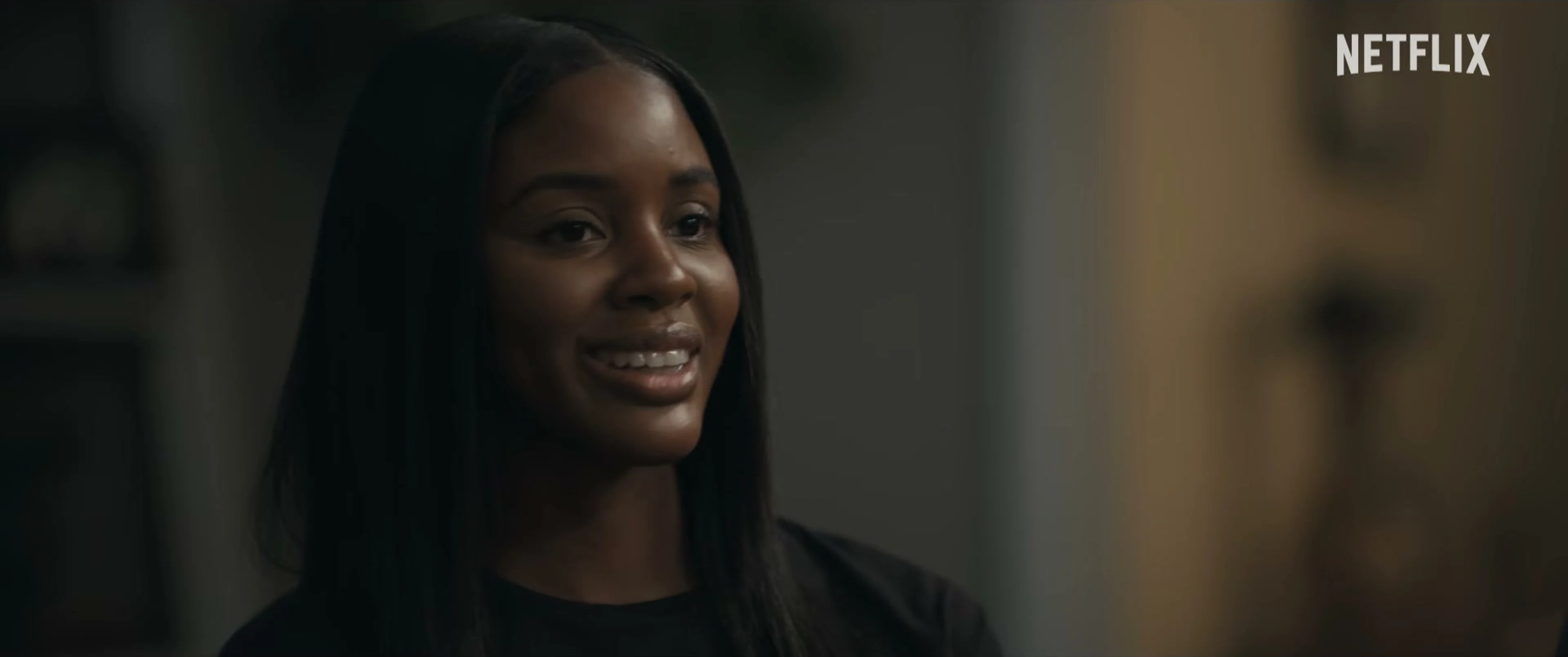 Naomi Baker looks toward someone during a conversation in Doing Life.
