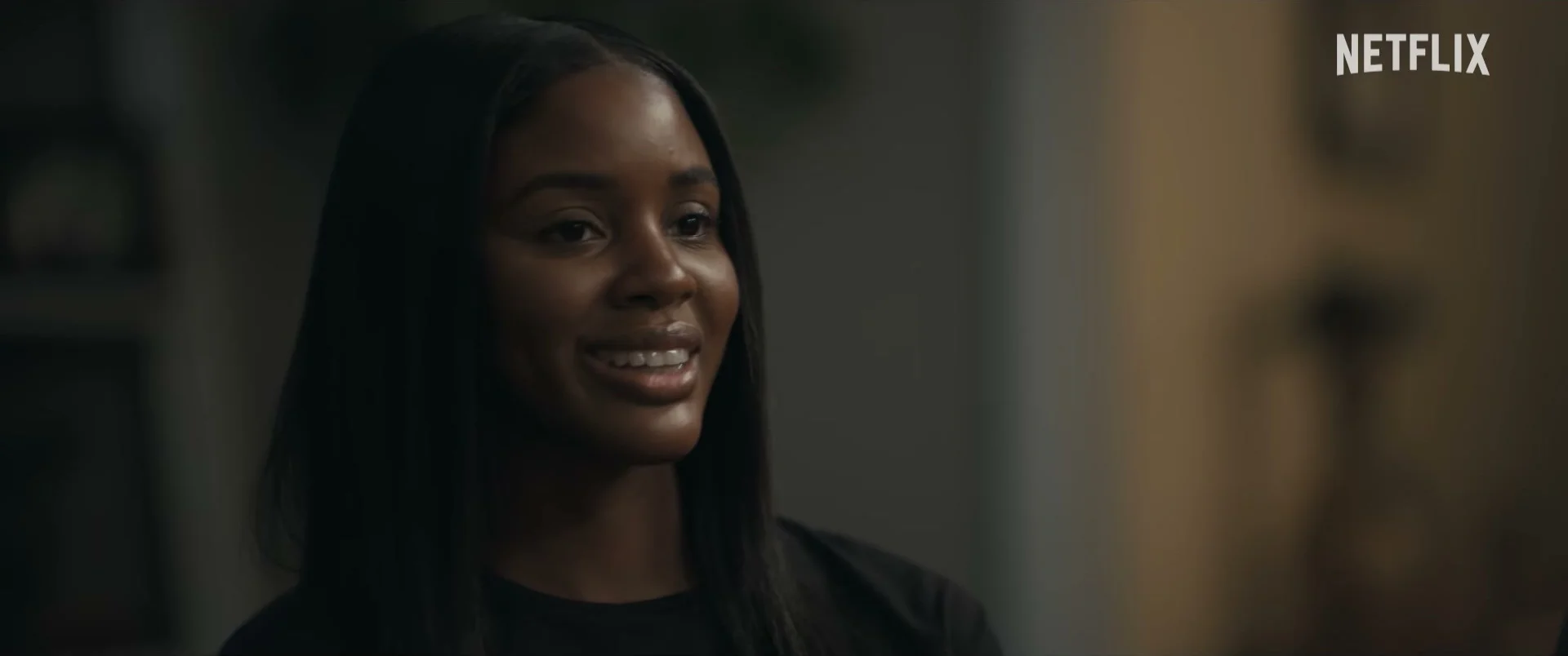 Naomi Baker looks toward someone during a conversation in Doing Life.