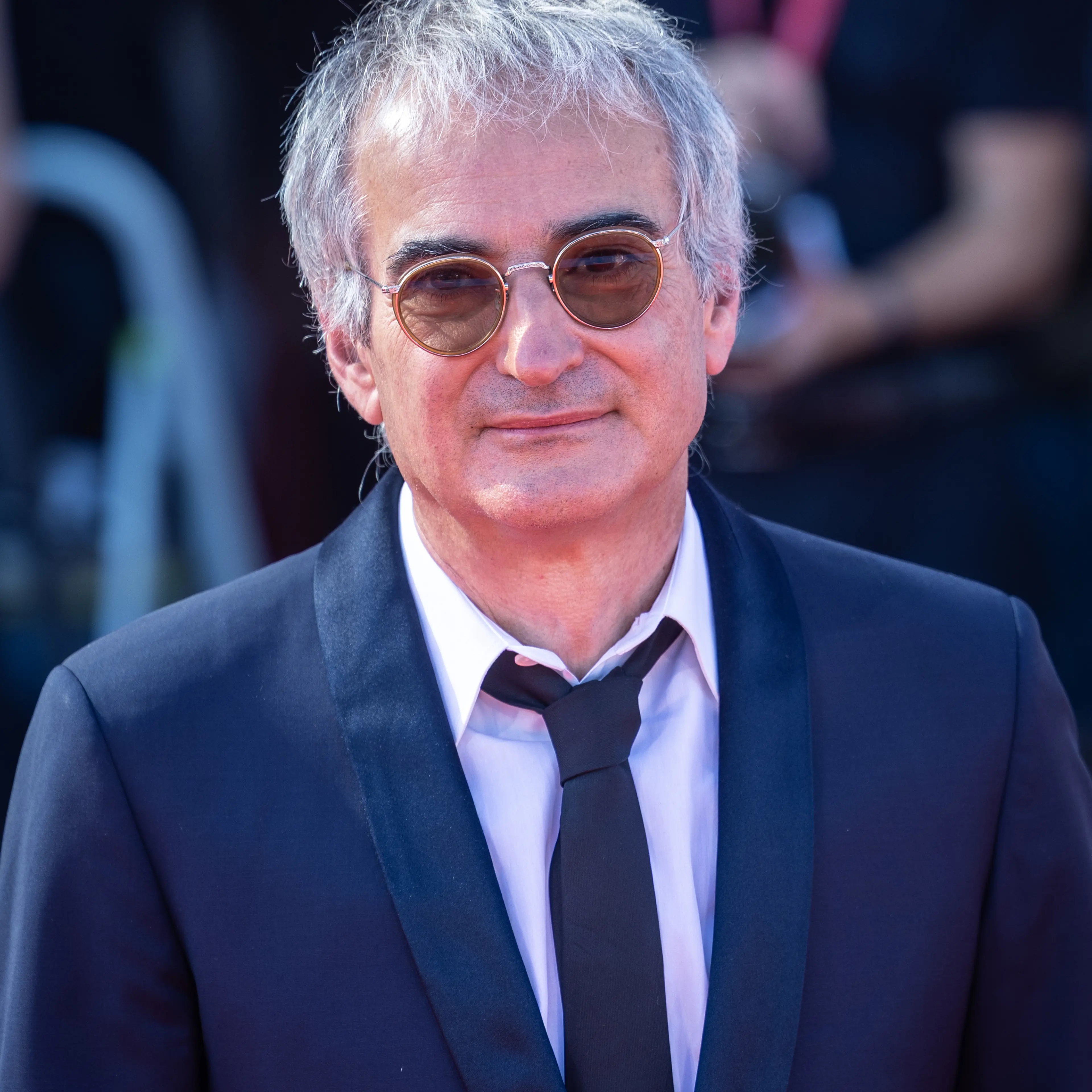 Director Olivier Assayas poses at a 2025 film event.