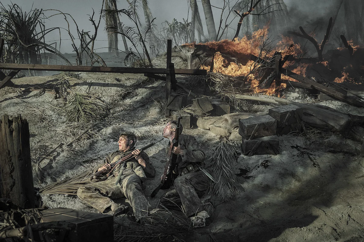 Tom Francis as David Schreiner and Bill Skarsgård as Bob Baumann take cover during combat in The Mosquito Bowl.