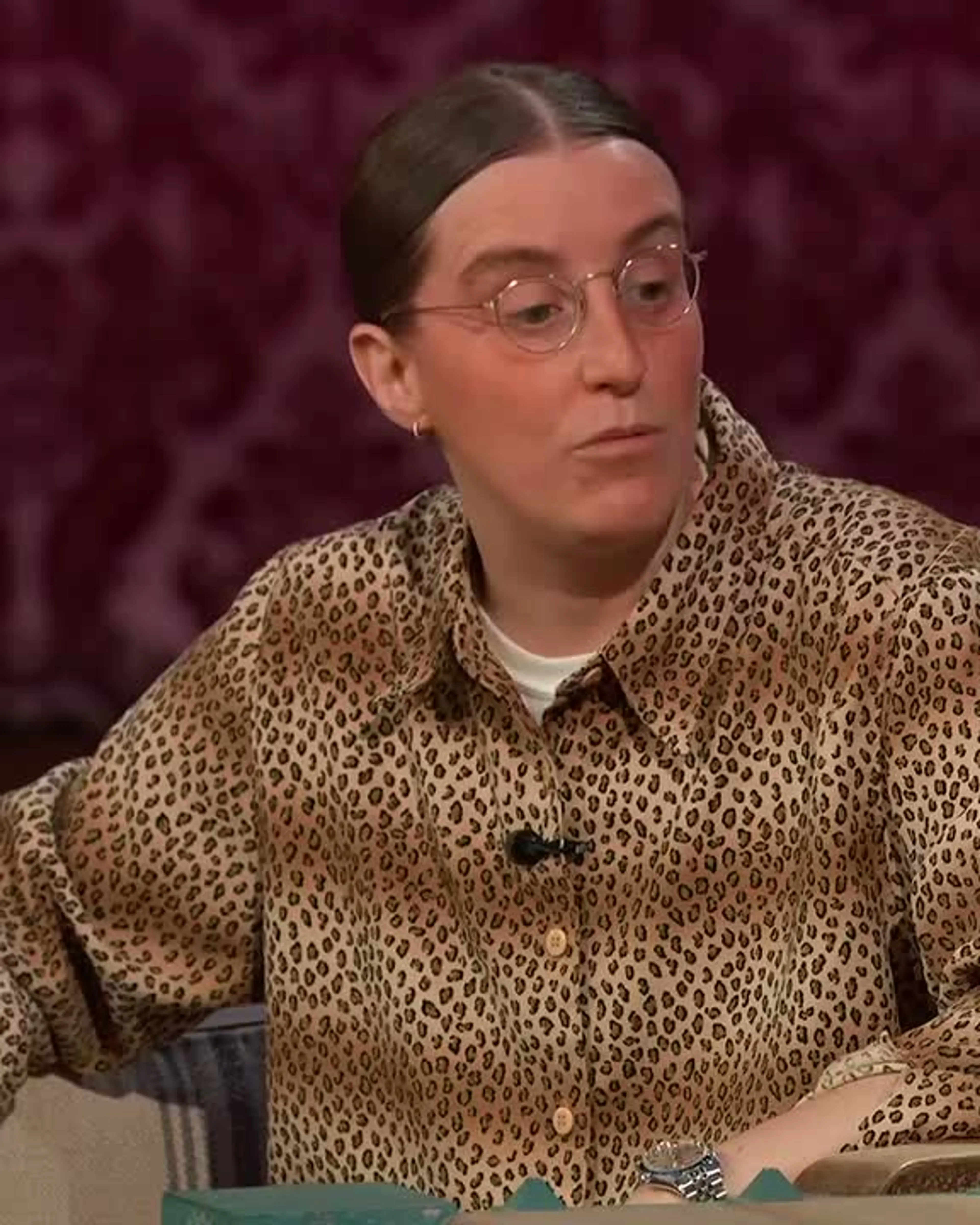 Robby Hoffman talks with Jimmy Kimmel in a patterned shirt and round glasses.