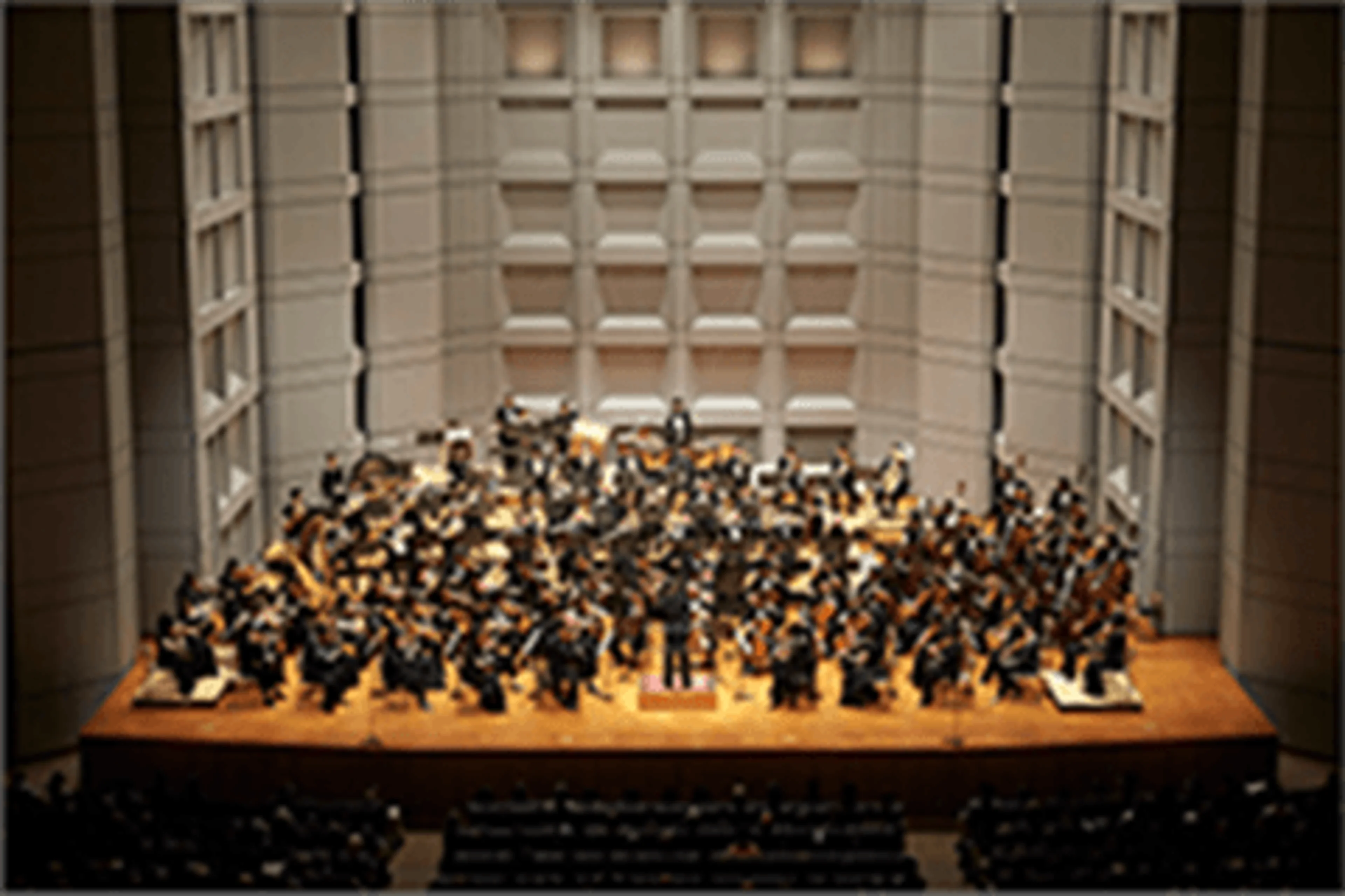 An orchestra performs in a concert hall in the official Frieren Film Concert materials.
