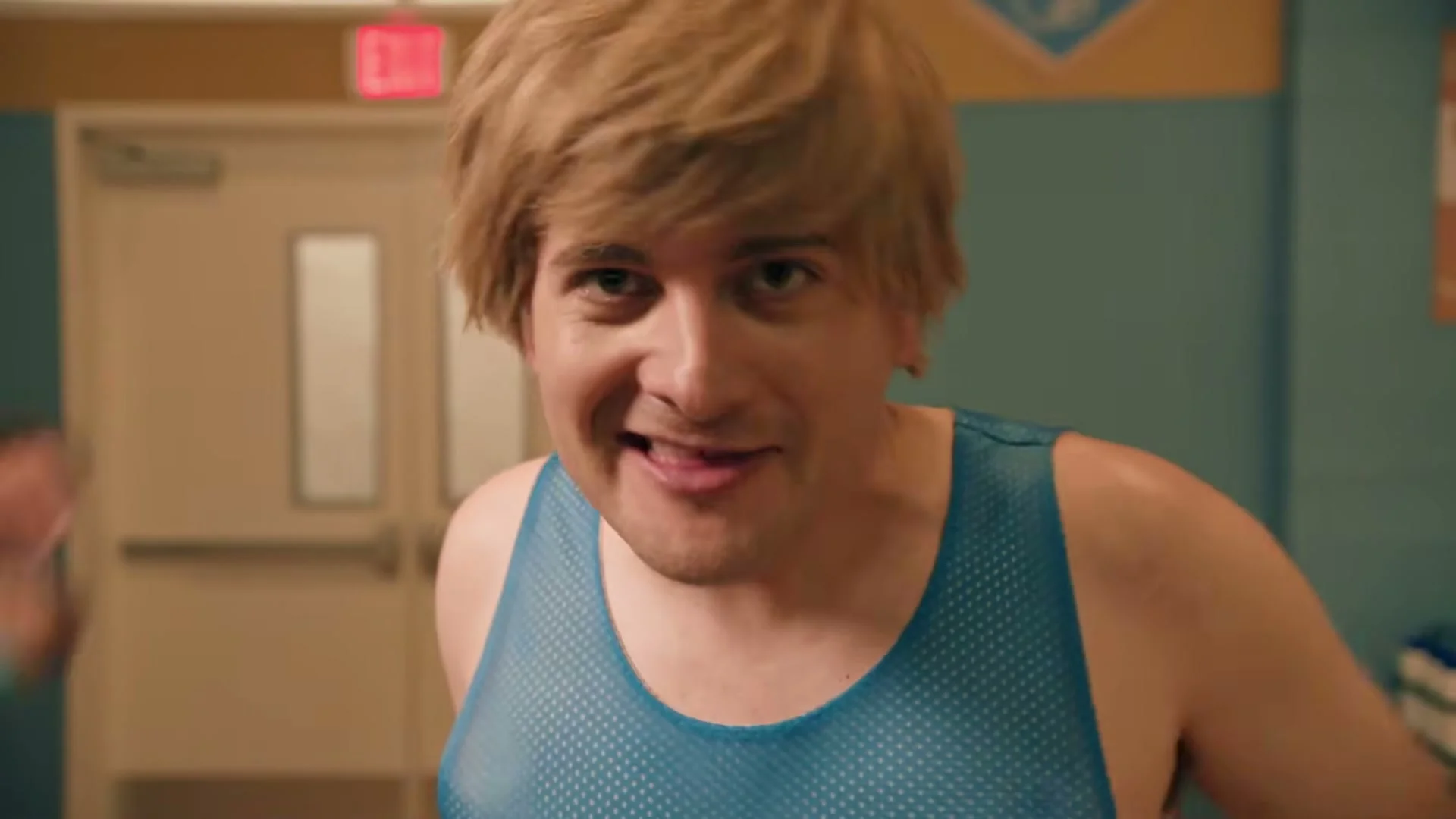 An actor playing a North High basketball teammate leans toward the camera in SNL’s North High sketch.