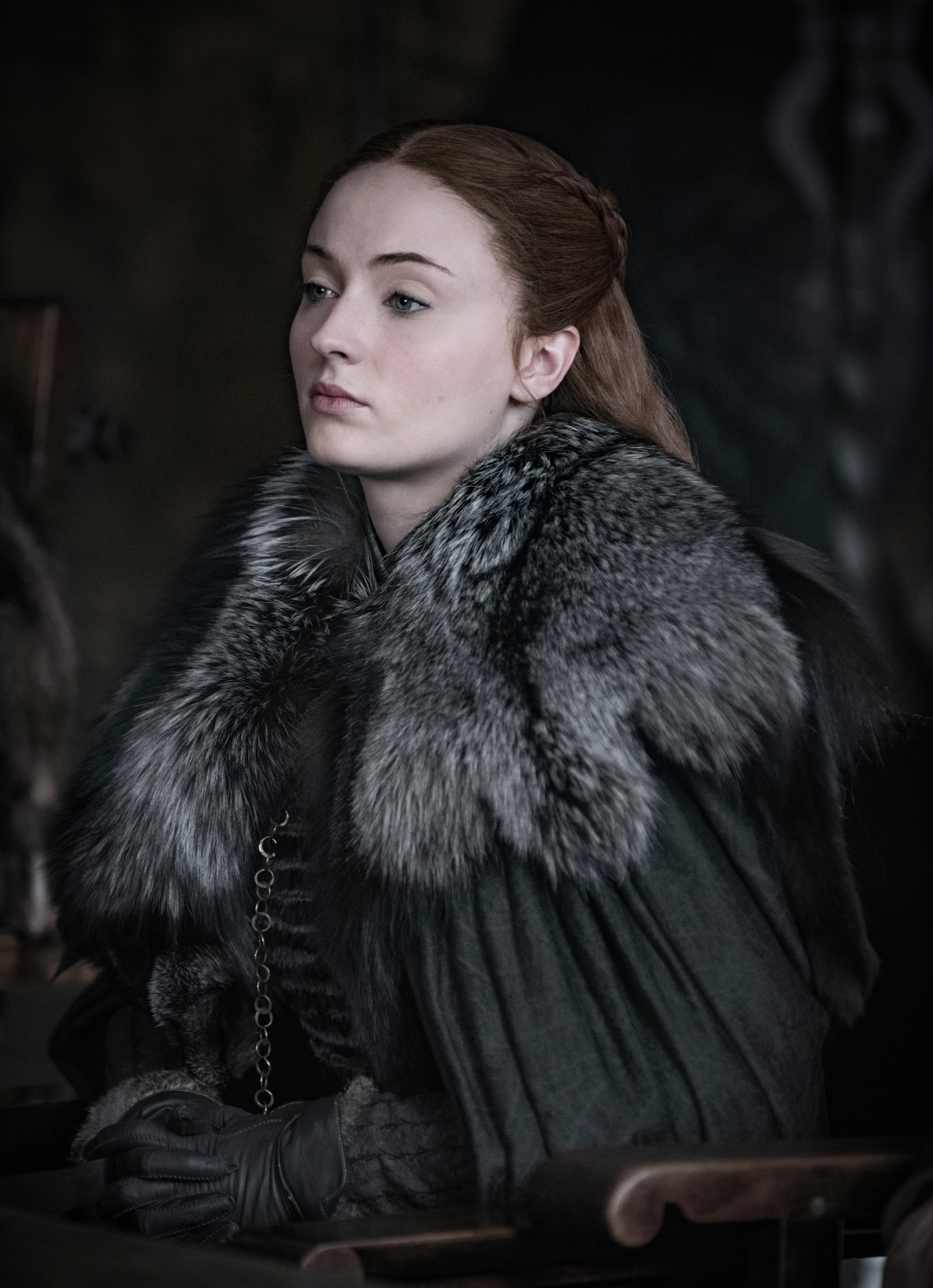 Sophie Turner as Sansa Stark sits in Winterfell in Game of Thrones.