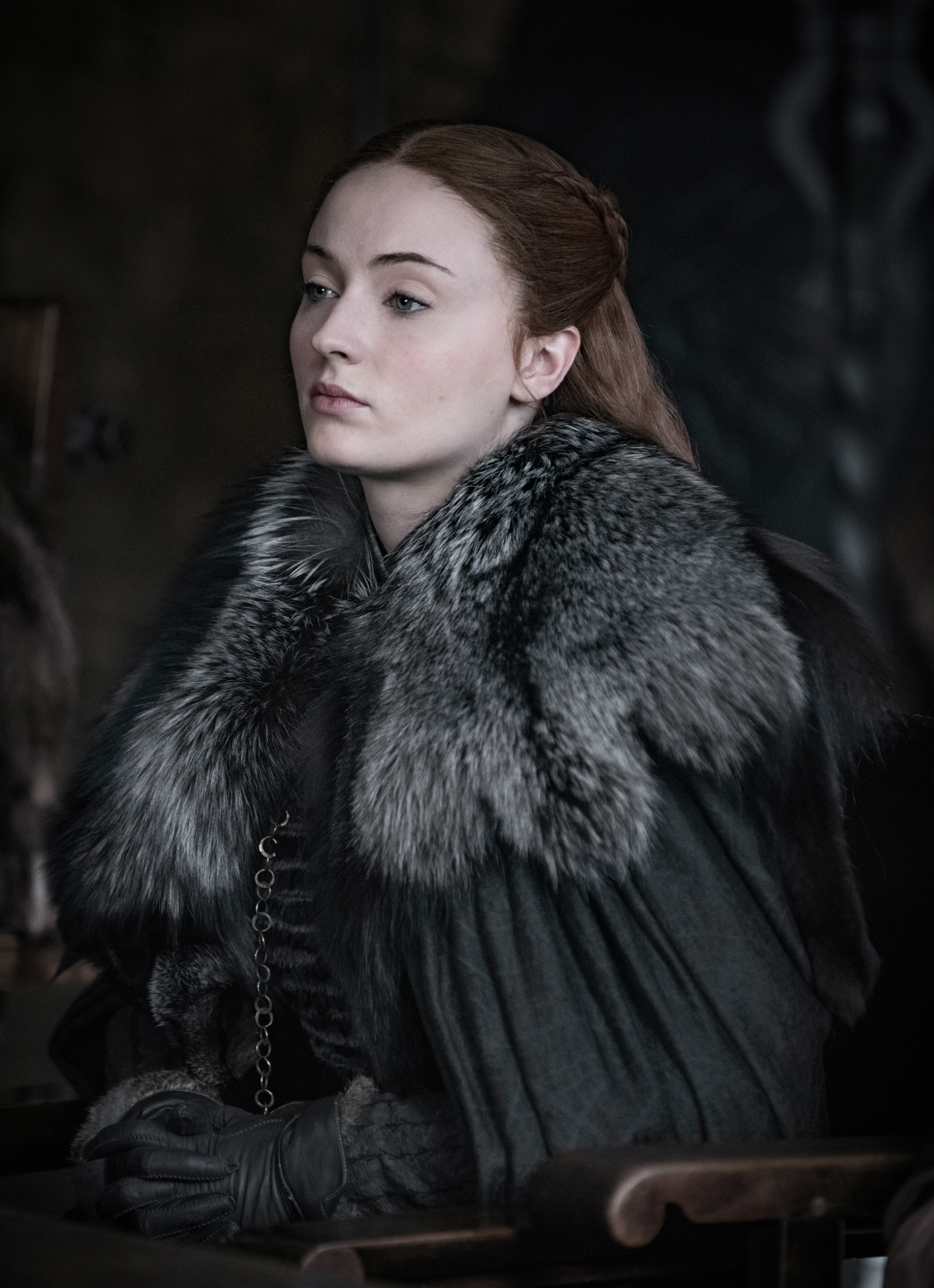 Sophie Turner as Sansa Stark sits in Winterfell in Game of Thrones.