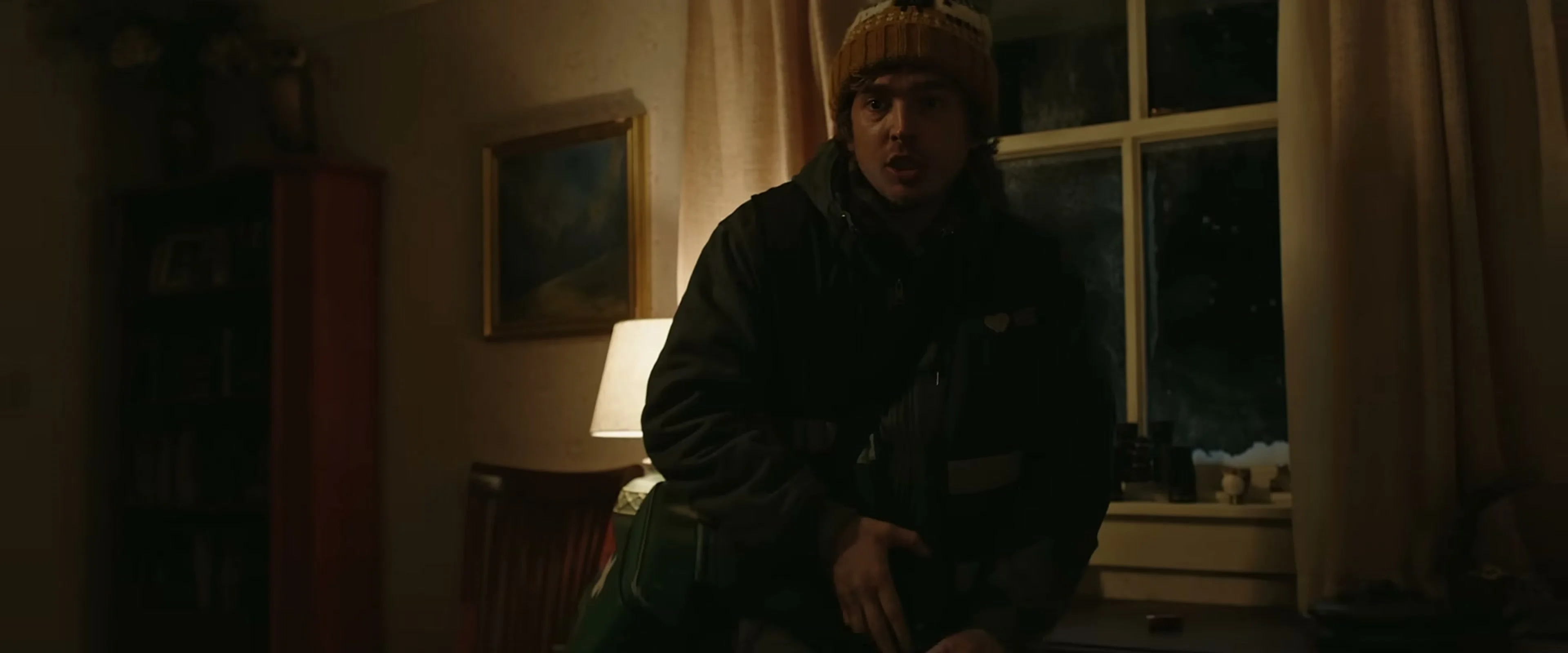 Bryan stands inside a dark house during the Resident Evil outbreak.