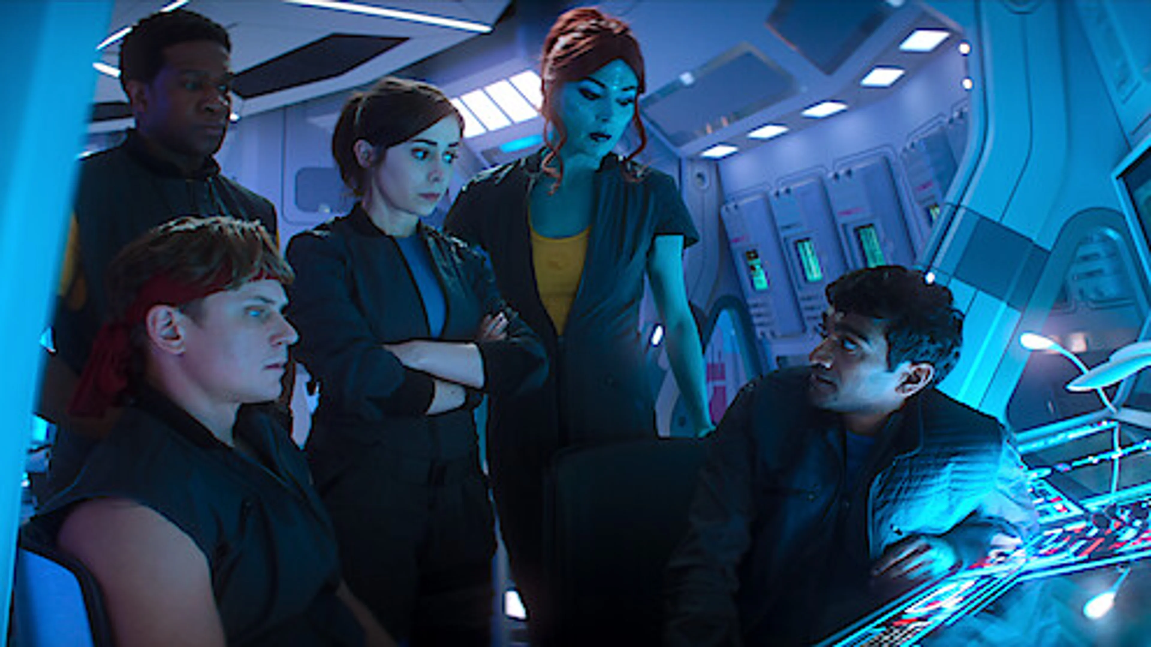 Five Black Mirror Season 7 characters gather around a glowing control console in a spaceship interior.