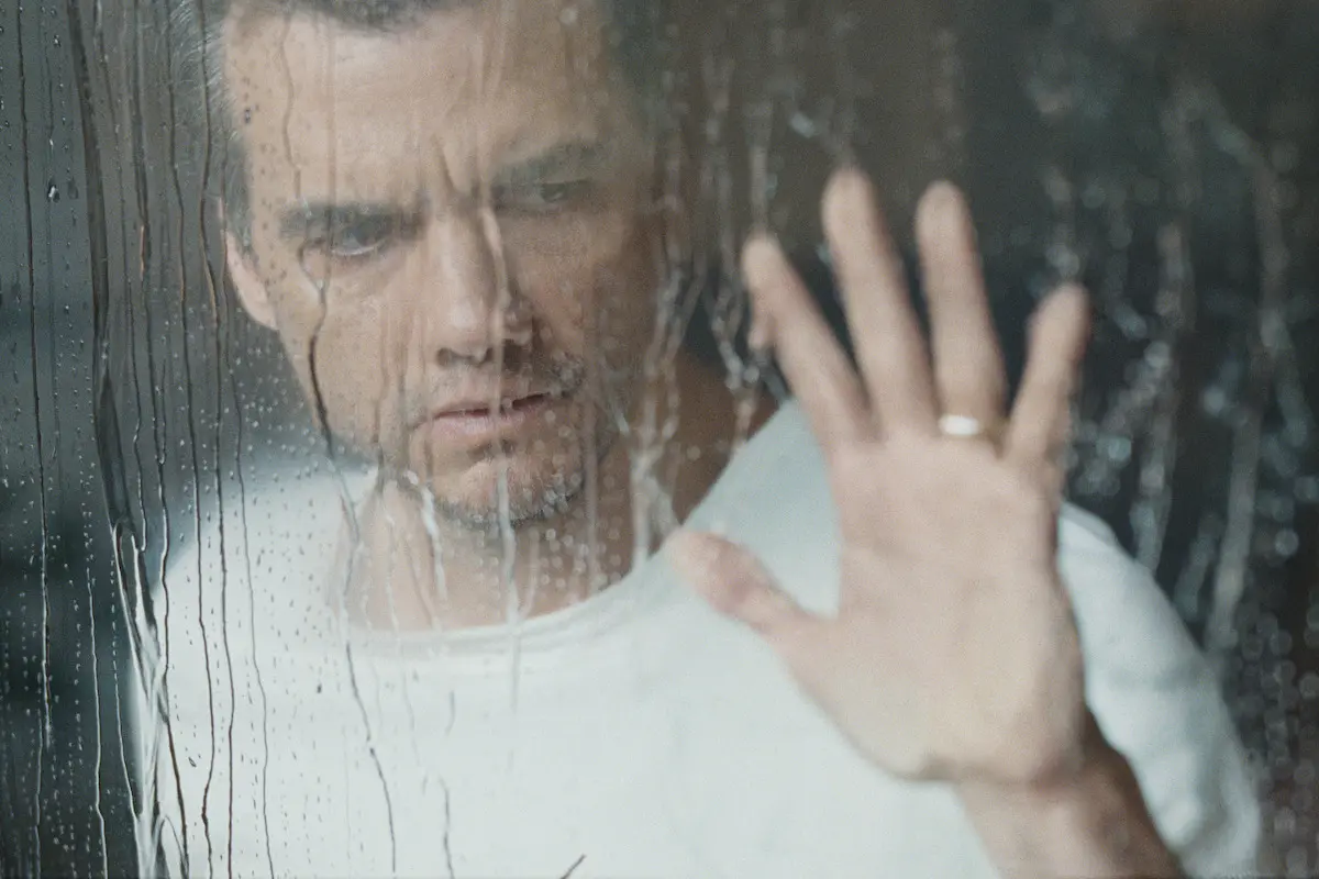 Jason looks through a rain-covered window in The Last House.