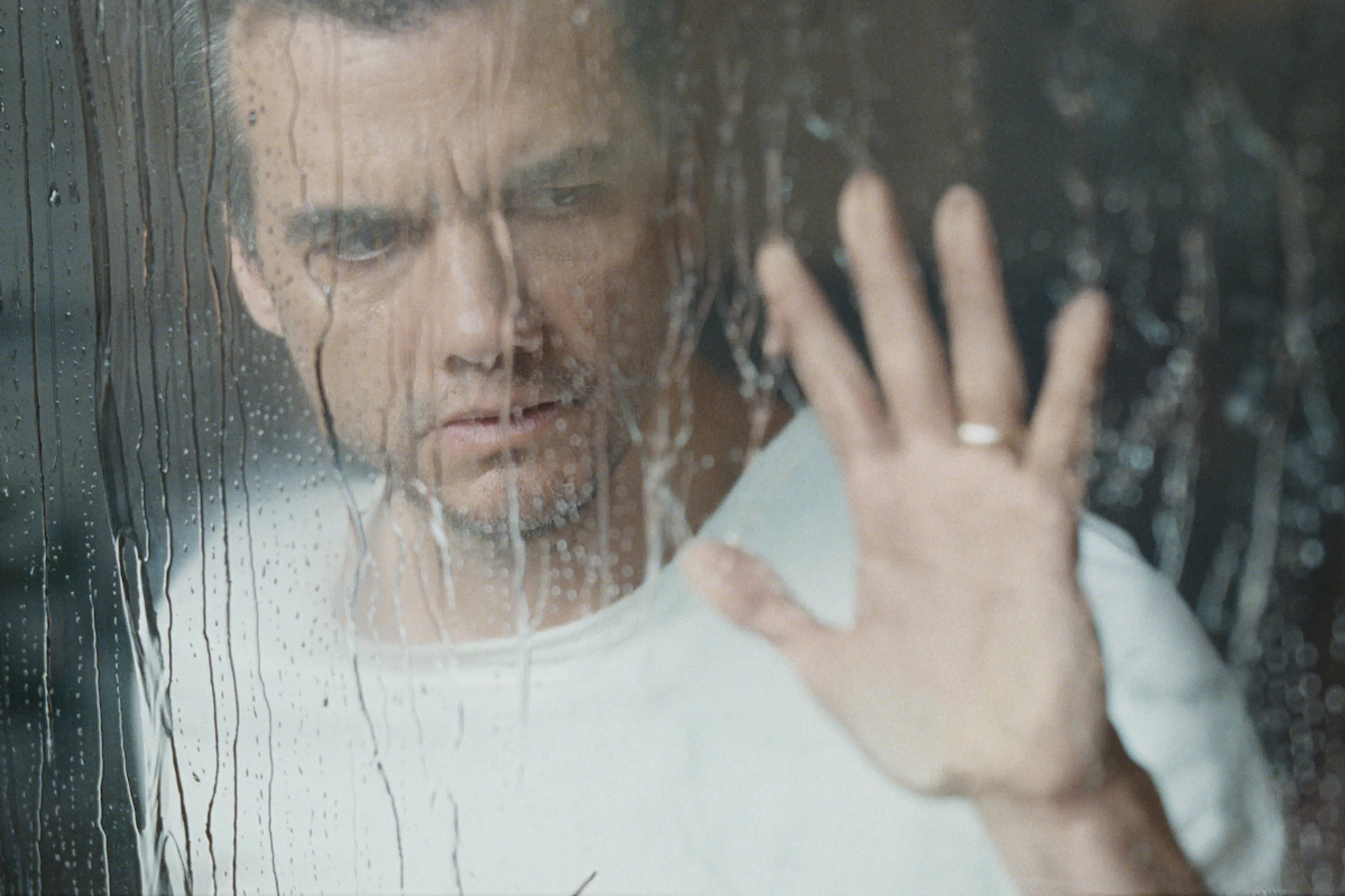 Jason looks through a rain-covered window in The Last House.