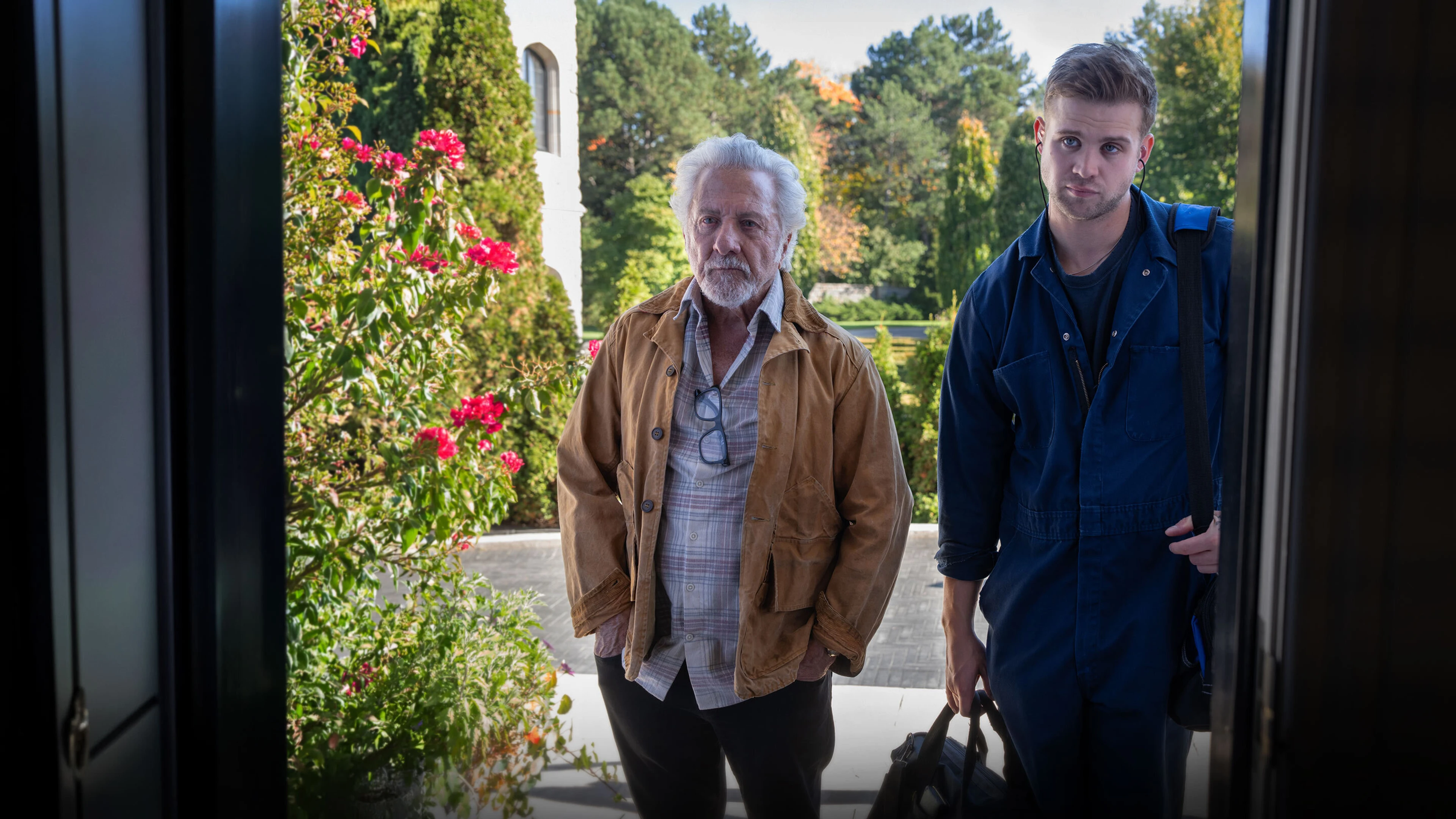 Harry and Niki stand outside an open doorway.