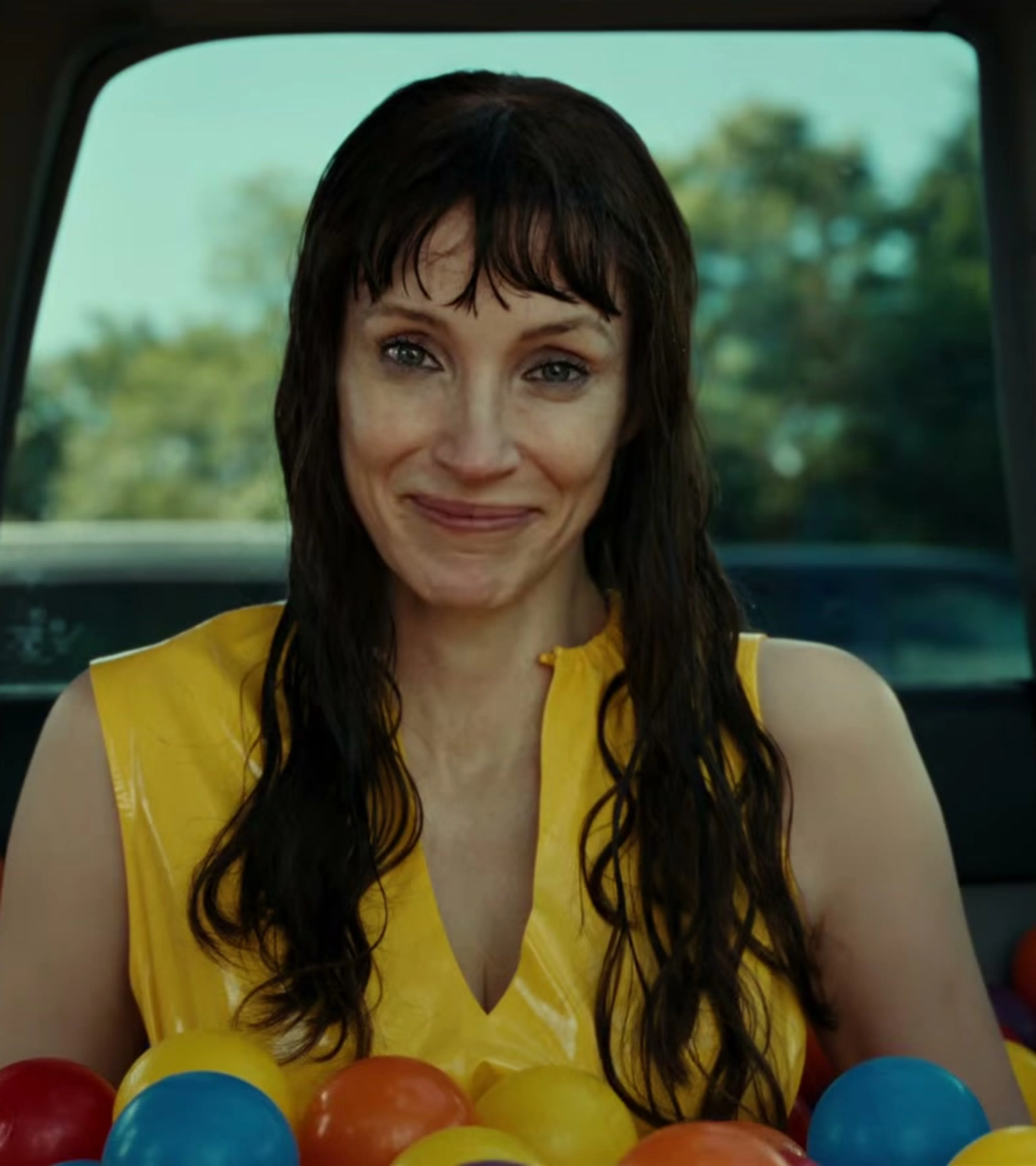 Jessica Chastain as Other Mommy sits inside a car filled with colorful plastic balls.