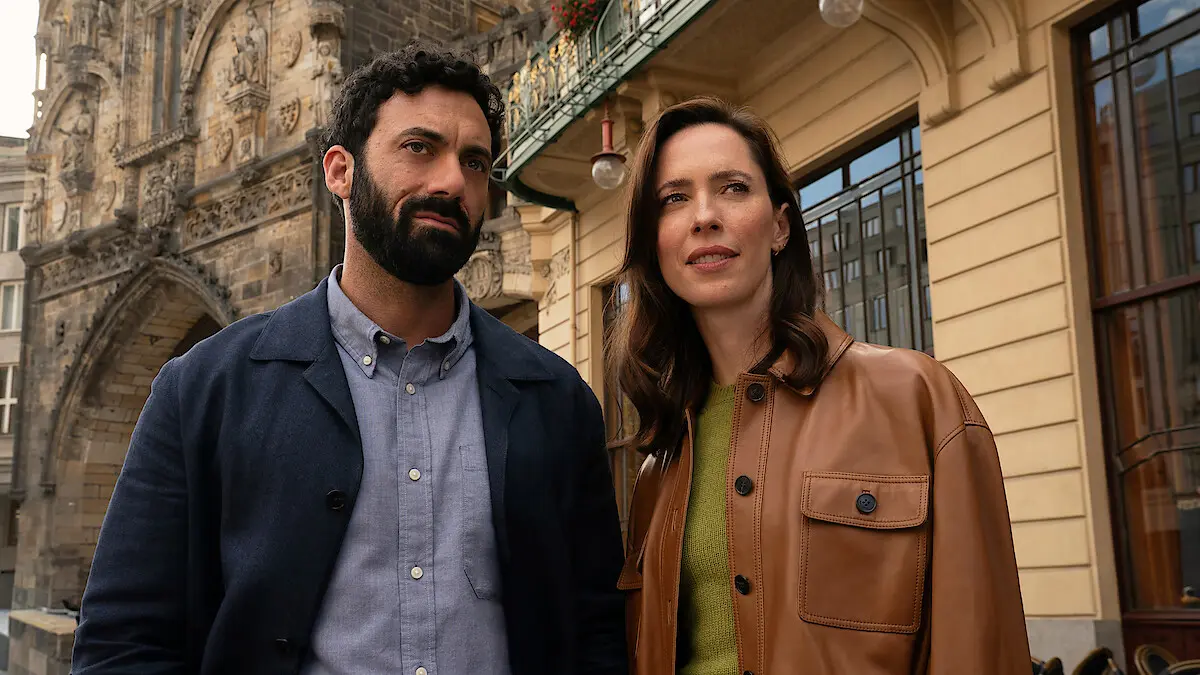 Morgan Spector as Robert Langdon and Rebecca Hall as Katherine Solomon stand together in Prague.