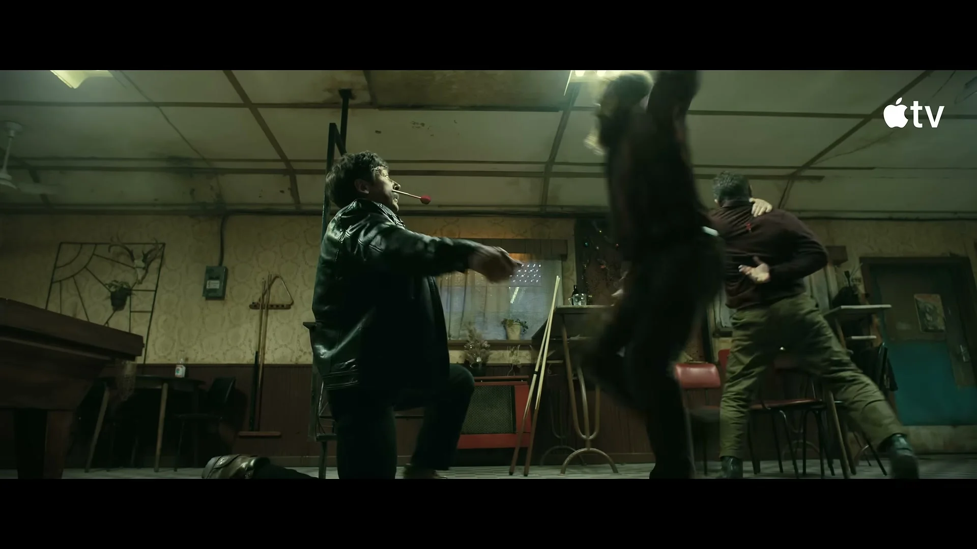 Nikolai fights two men inside a dim green room in Mayday.