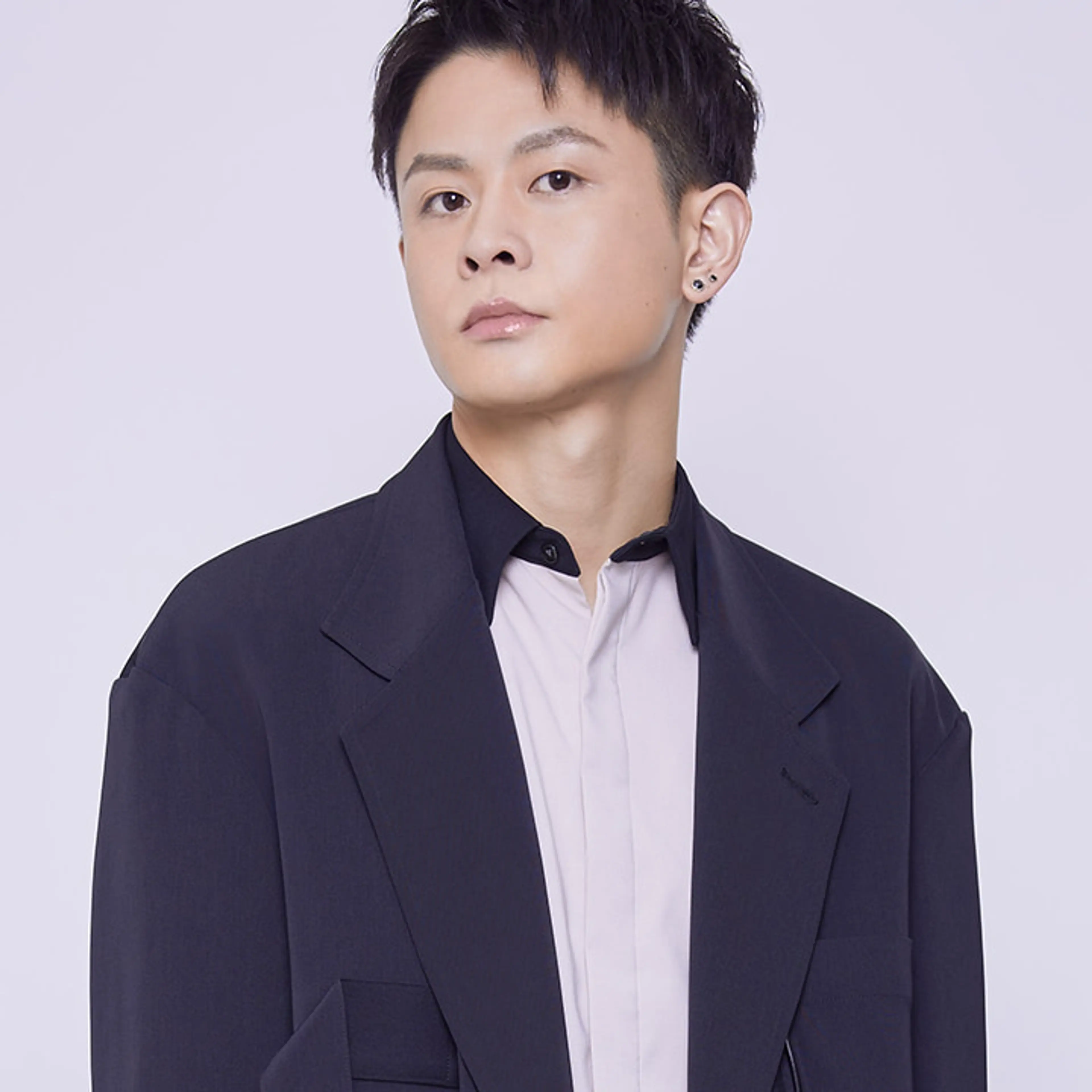 Shoya Ishige wearing a dark jacket over a white shirt.