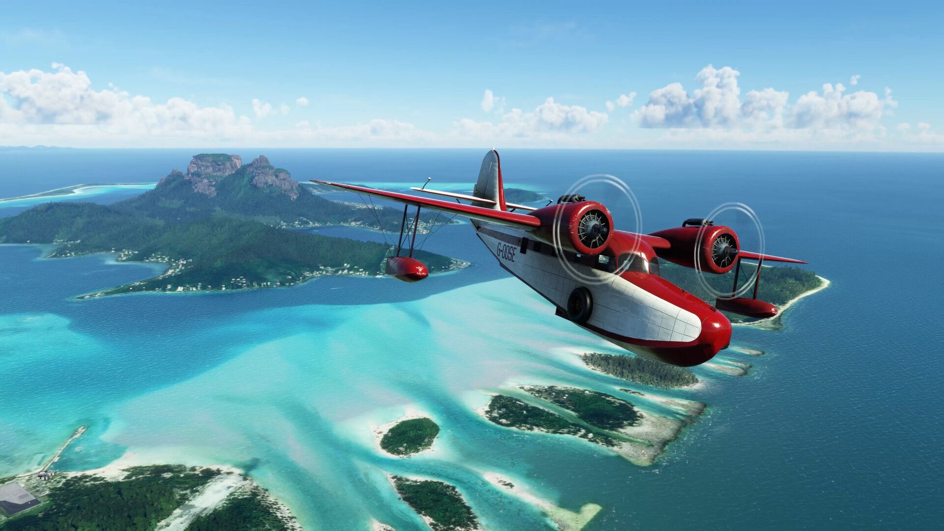 A red seaplane flies above tropical islands and bright blue water.