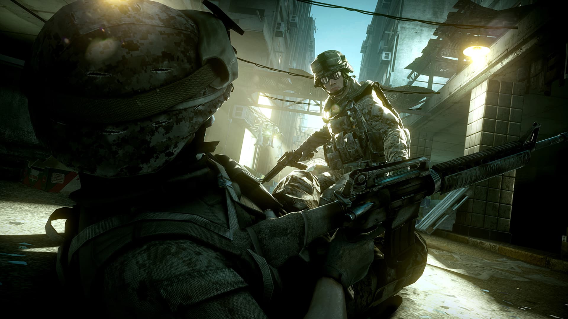 A soldier aims a rifle in a damaged street while another soldier crouches behind him.
