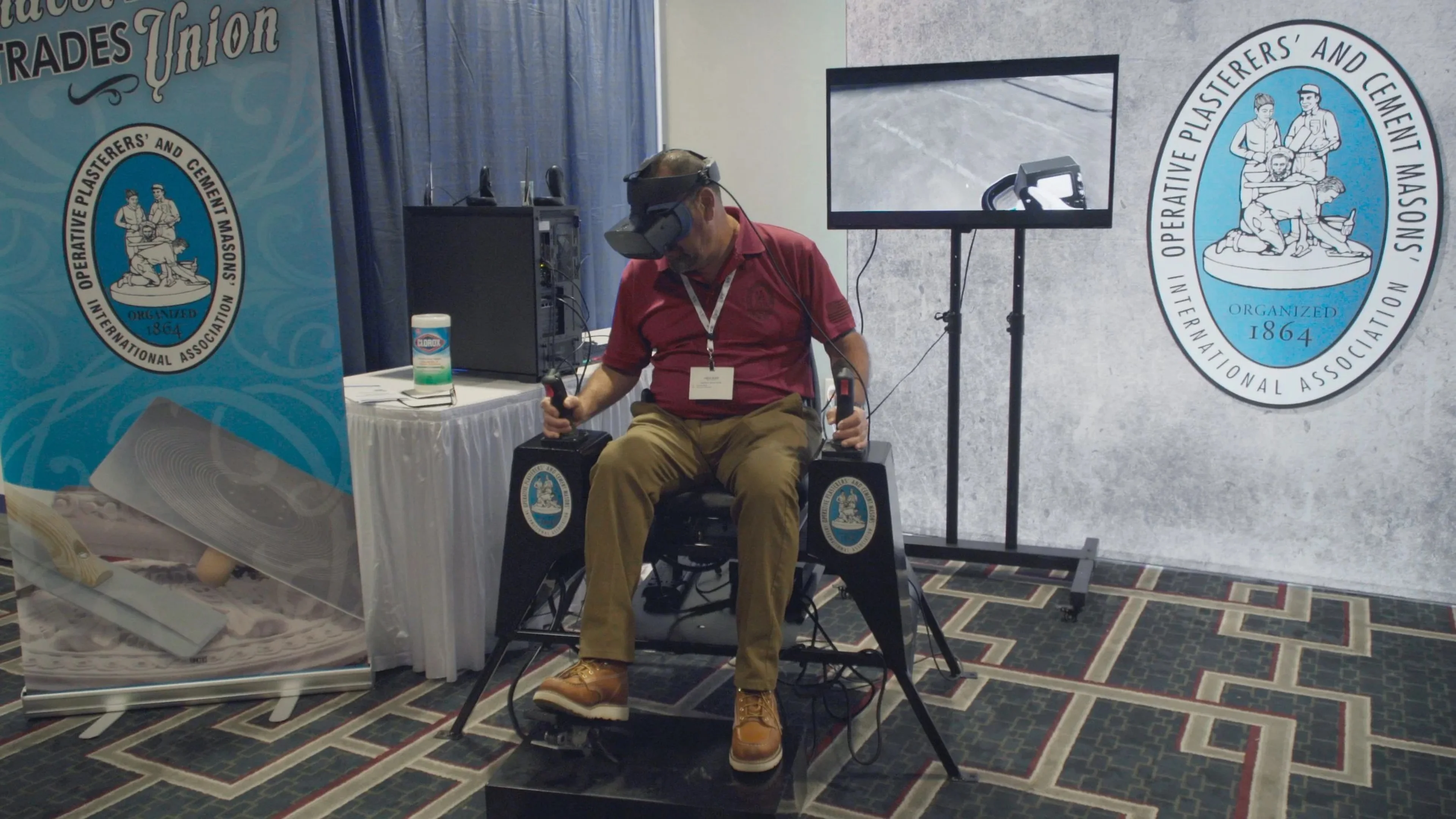 A participant tries a headset at a concrete industry event.