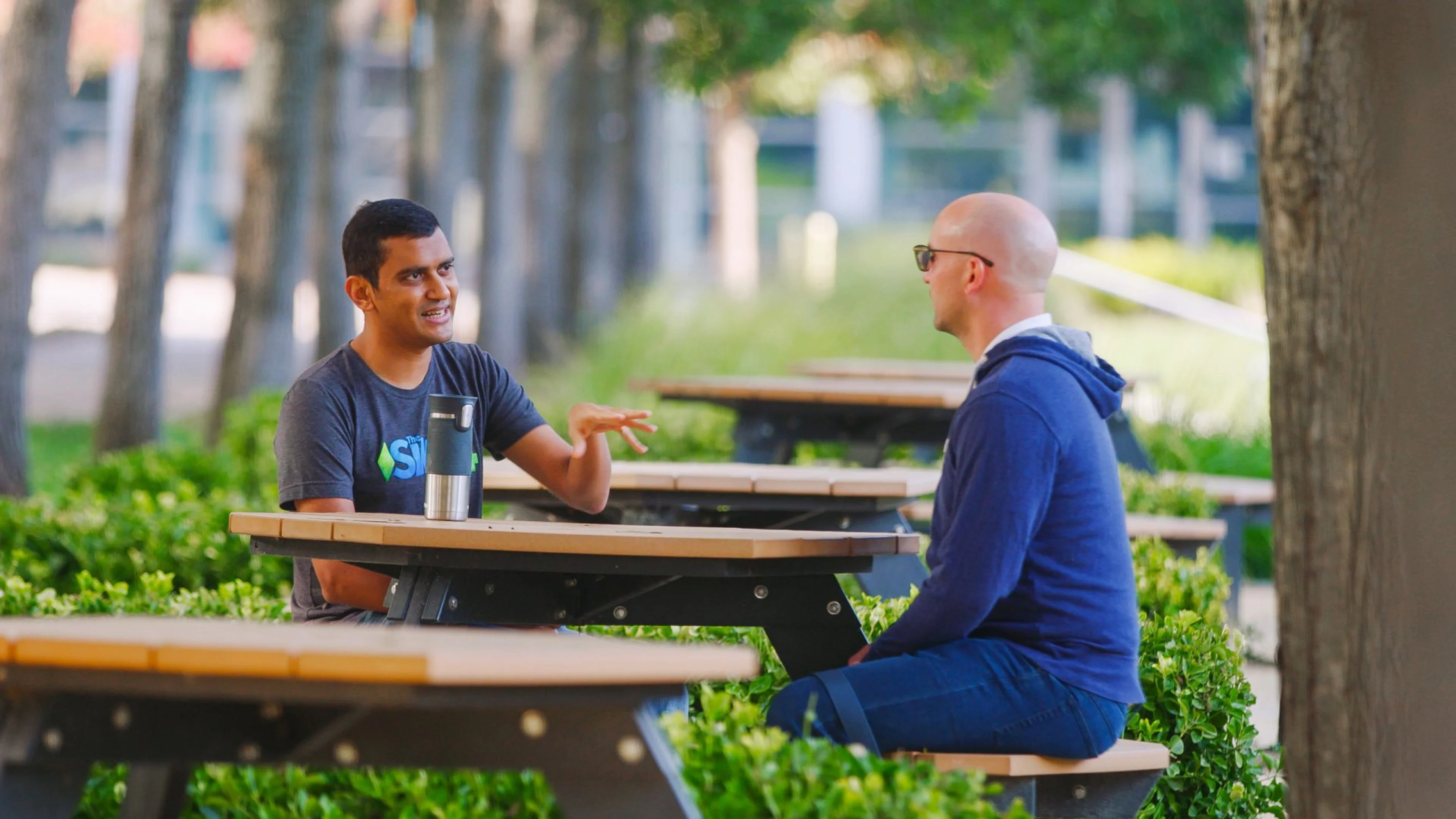 Two Electronic Arts employees speaking outside a Maxis studio