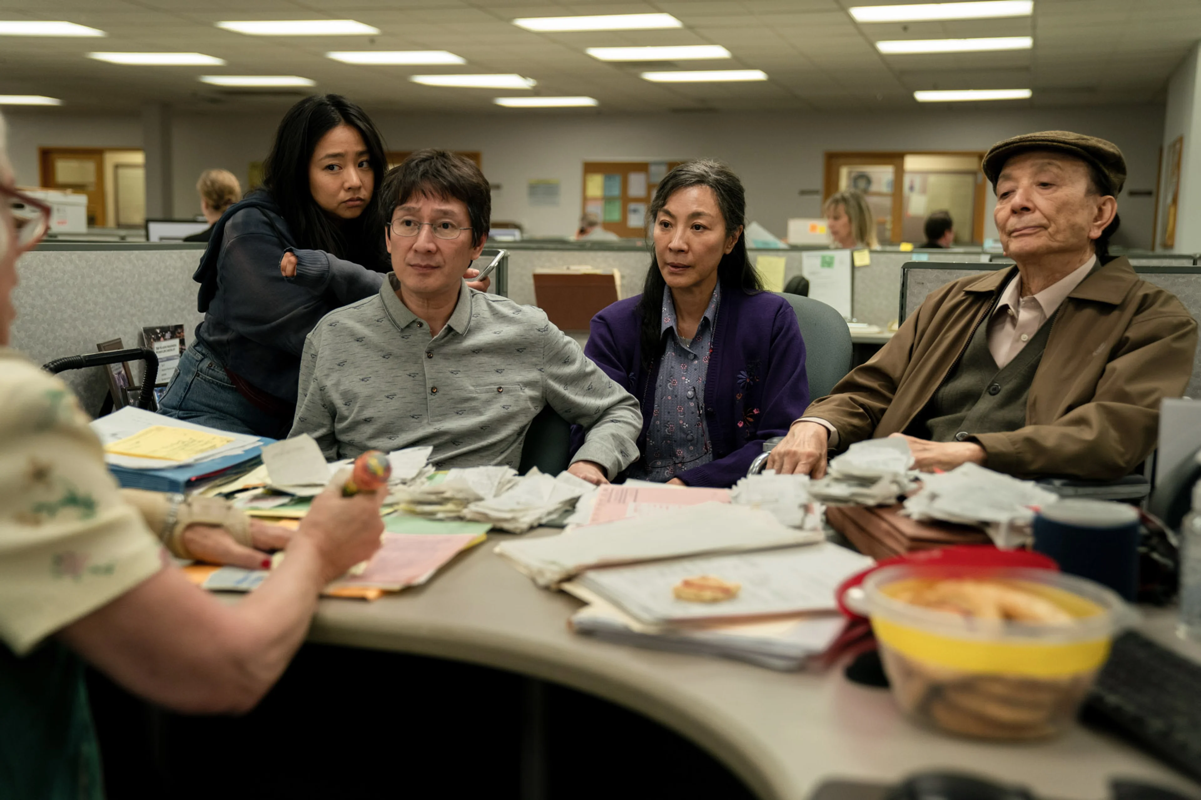 Stephanie Hsu, Ke Huy Quan, Michelle Yeoh and James Hong appear together at the tax office in Everything Everywhere All at Once.