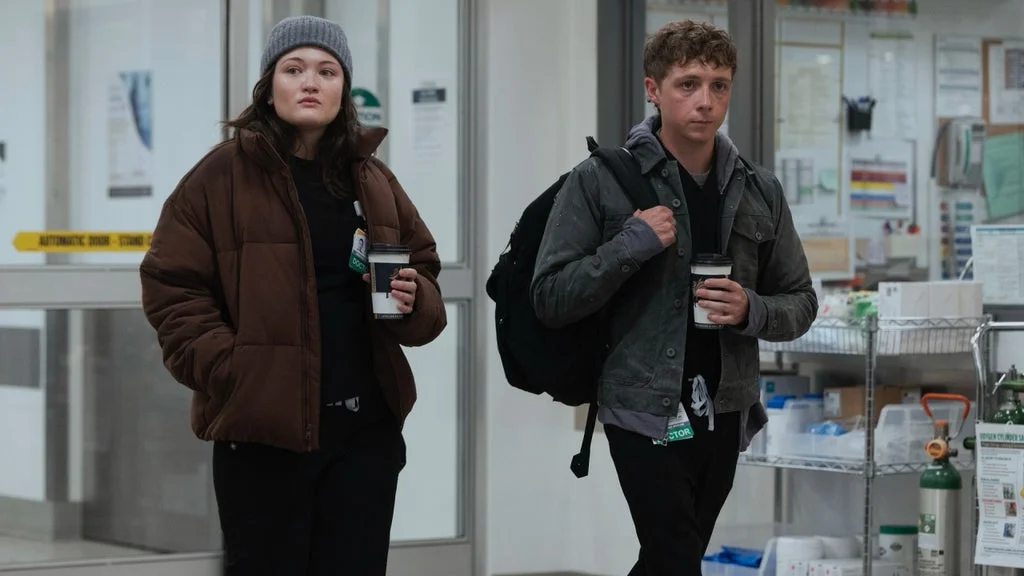 Two members of The Pitt's medical team talk near the emergency department in a Season 3 first-look image.