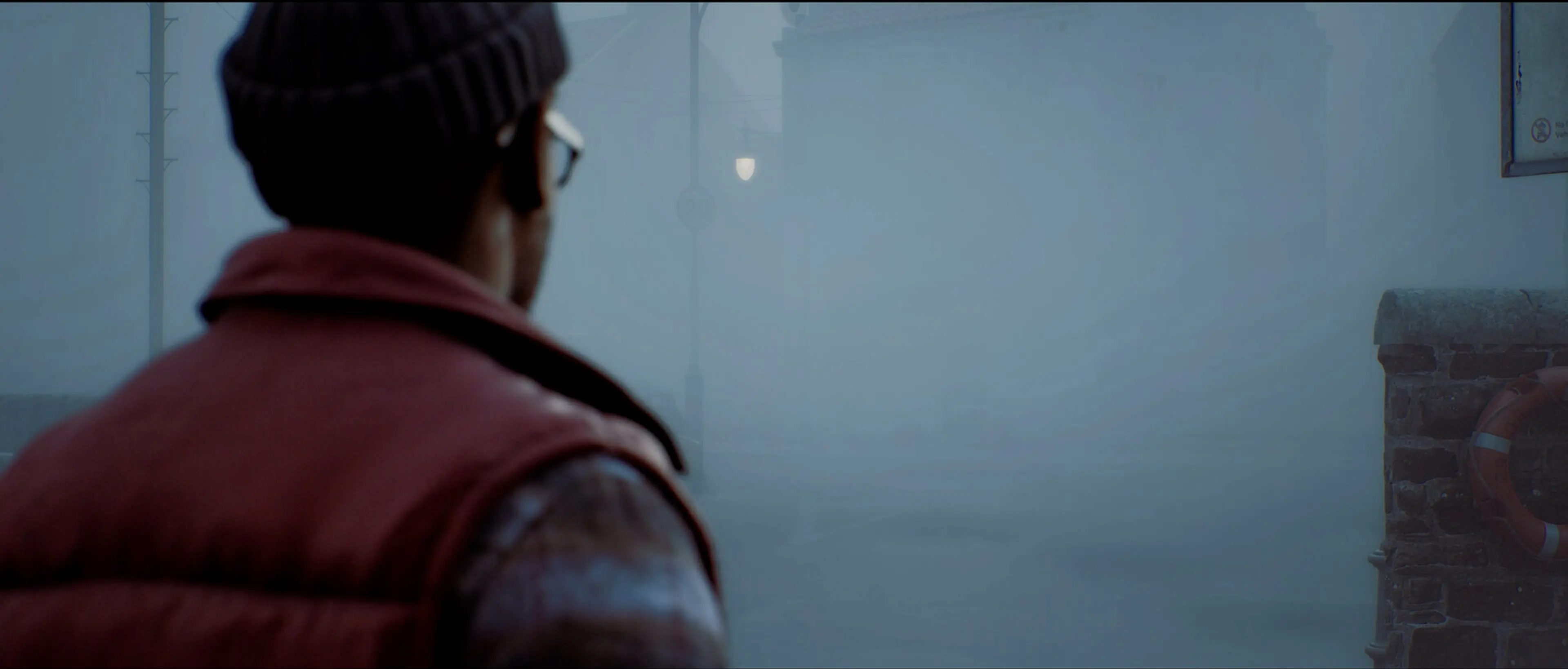 Simon looks down a foggy street, seen from behind his shoulder.