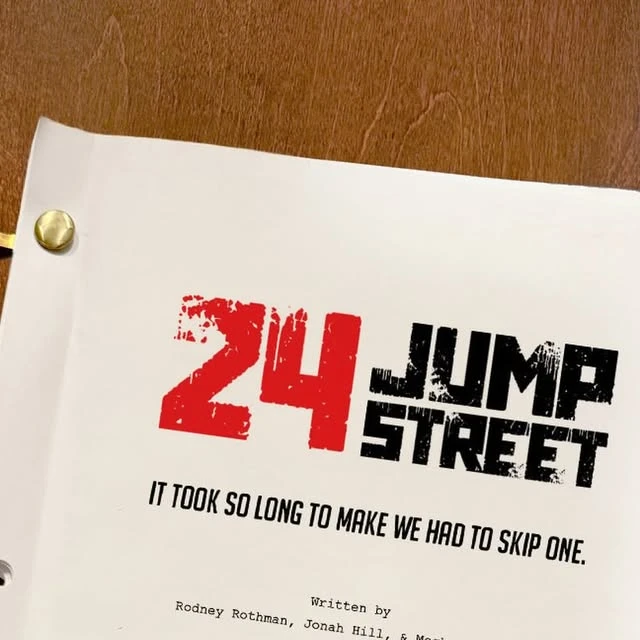 The 24 Jump Street screenplay cover rests on a wooden table.