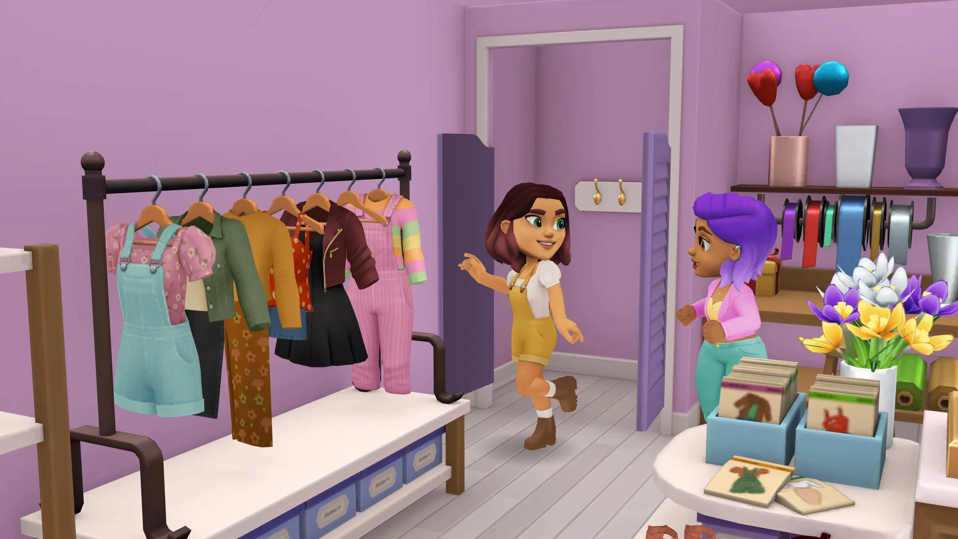 Tara stands beside outfits in a Wylde Flowers clothing shop.