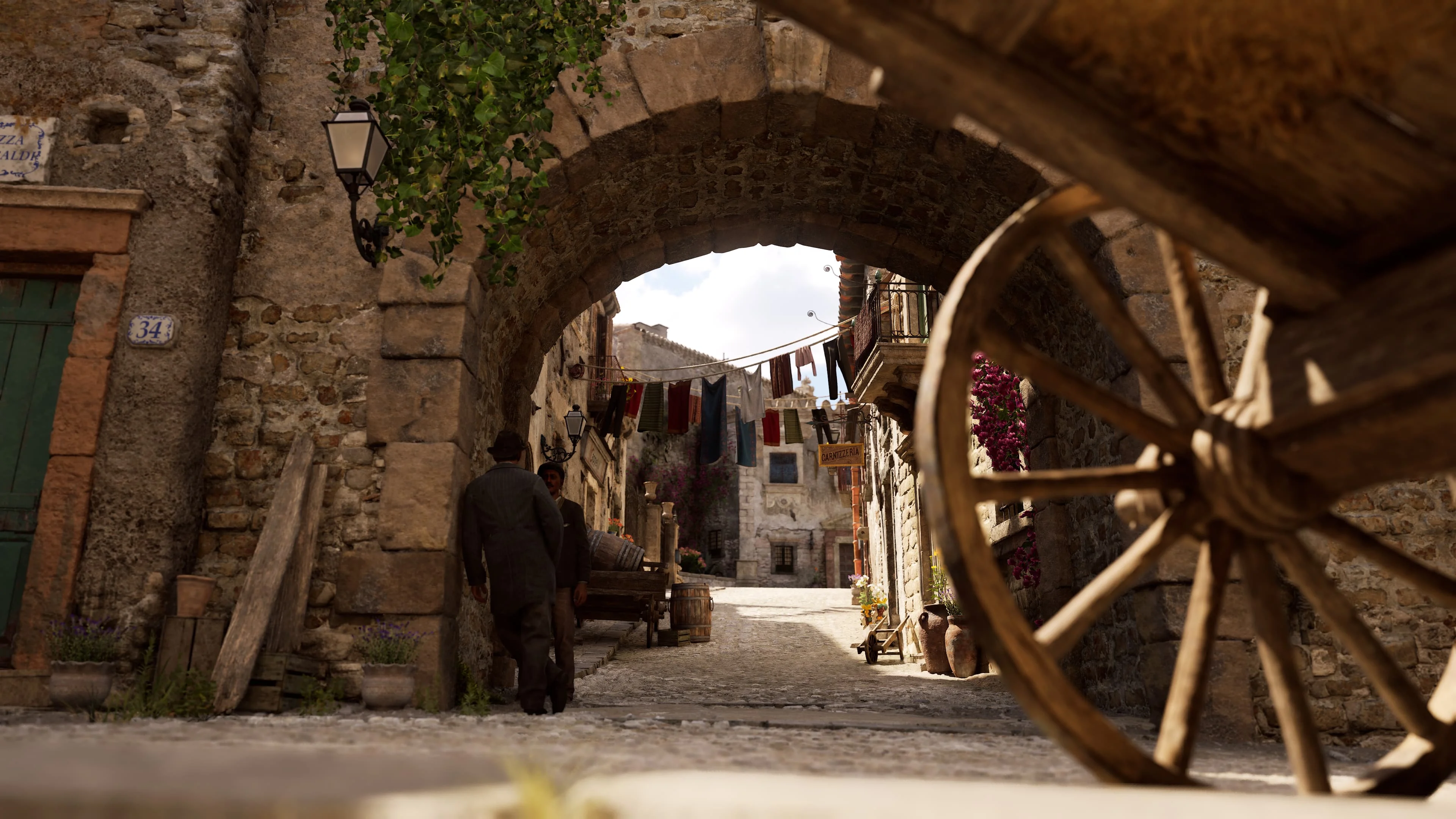 A horse and cart pass beneath a distant castle in an official Mafia: The Old Country screenshot.
