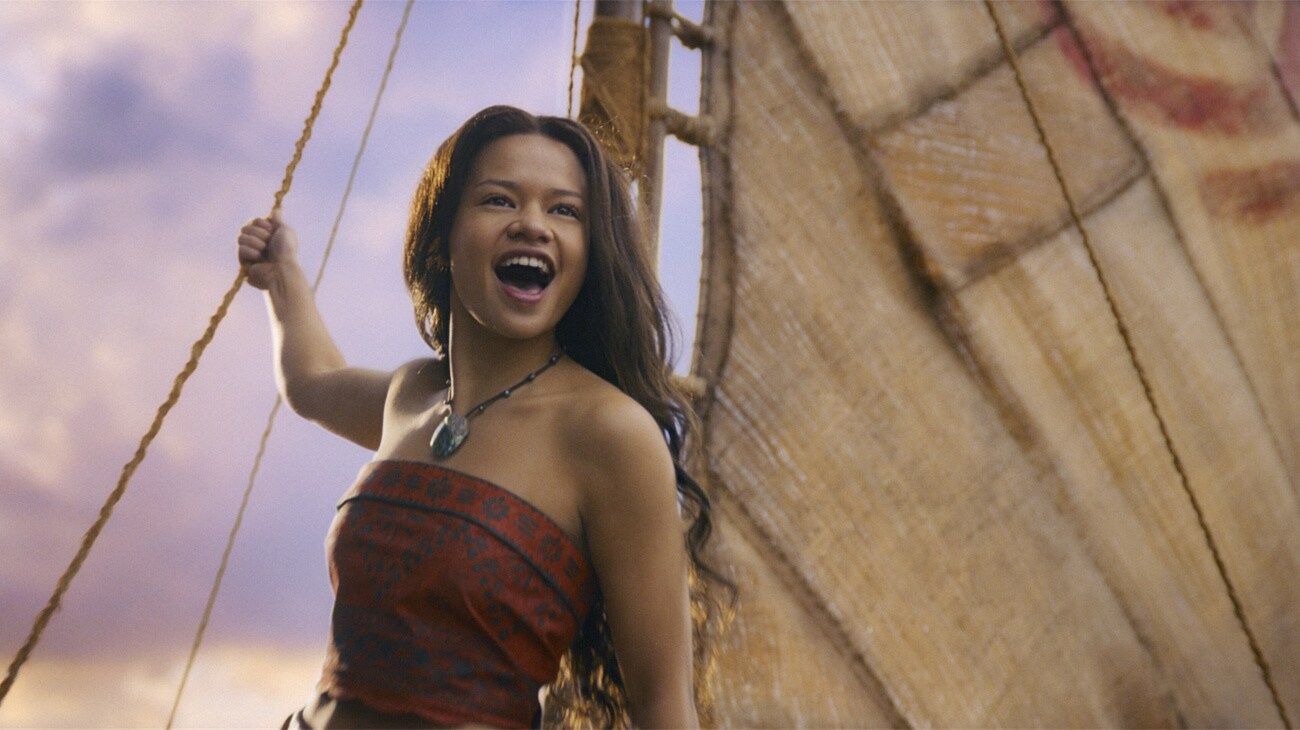 Moana smiles beneath the sail.