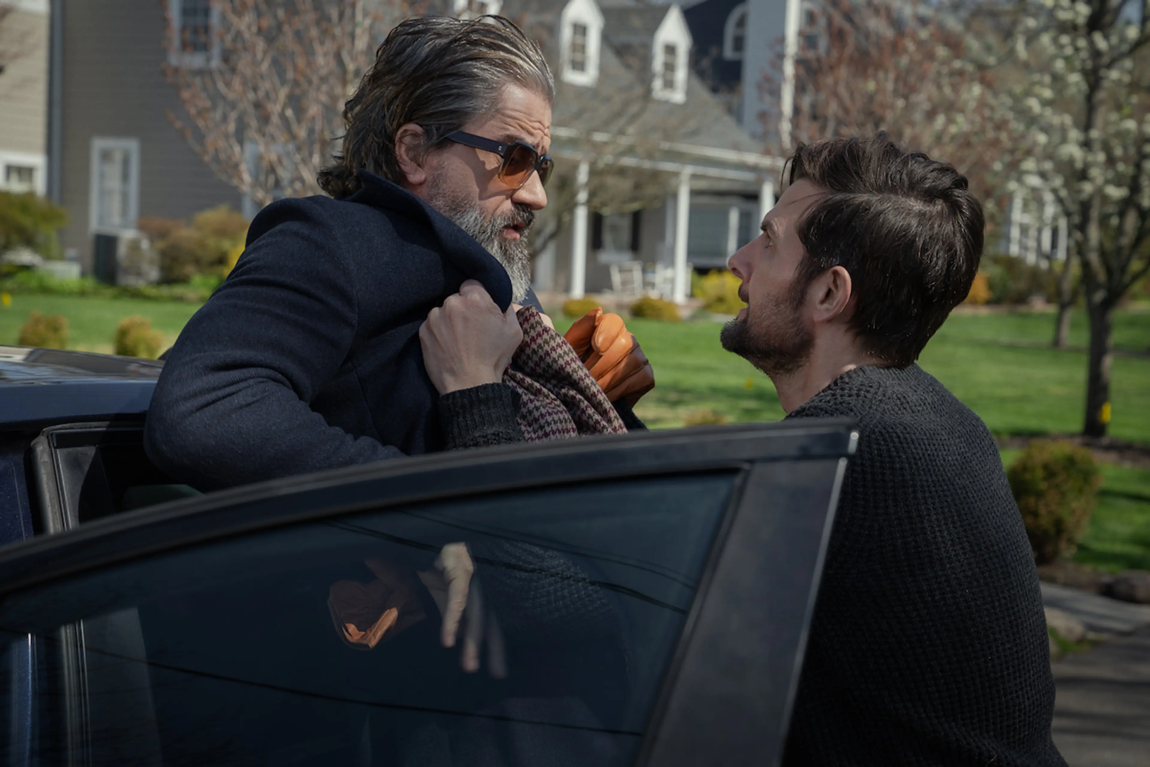 Tom Kennedy grabs Pete Willis beside a car outside the Kennedy home in The Whisper Man.