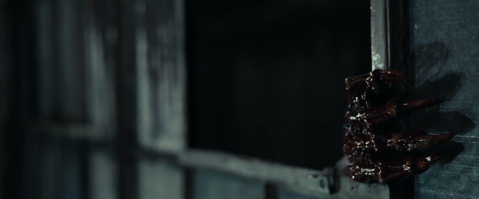A dark hand reaches around a wall in The Cycle trailer.
