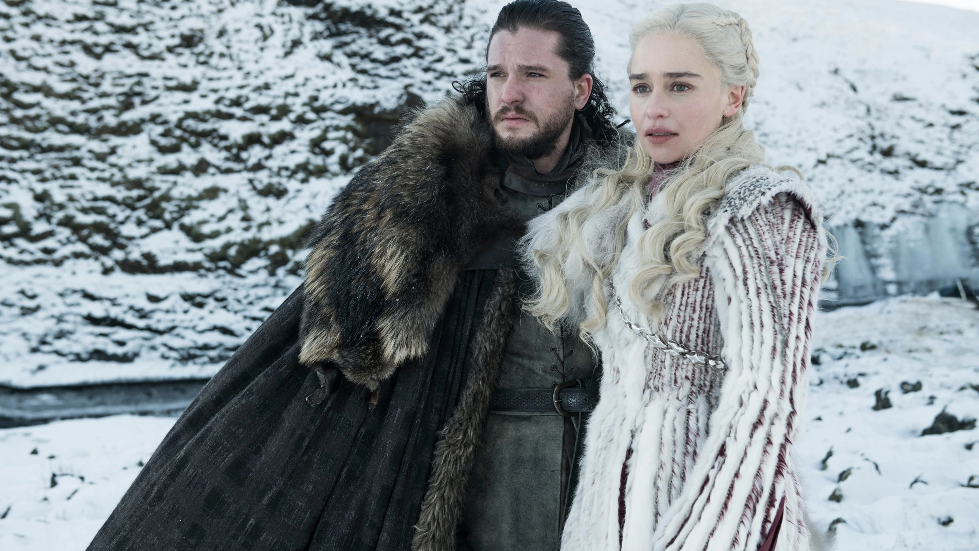 Kit Harington as Jon Snow stands beside Emilia Clarke as Daenerys Targaryen in Game of Thrones.