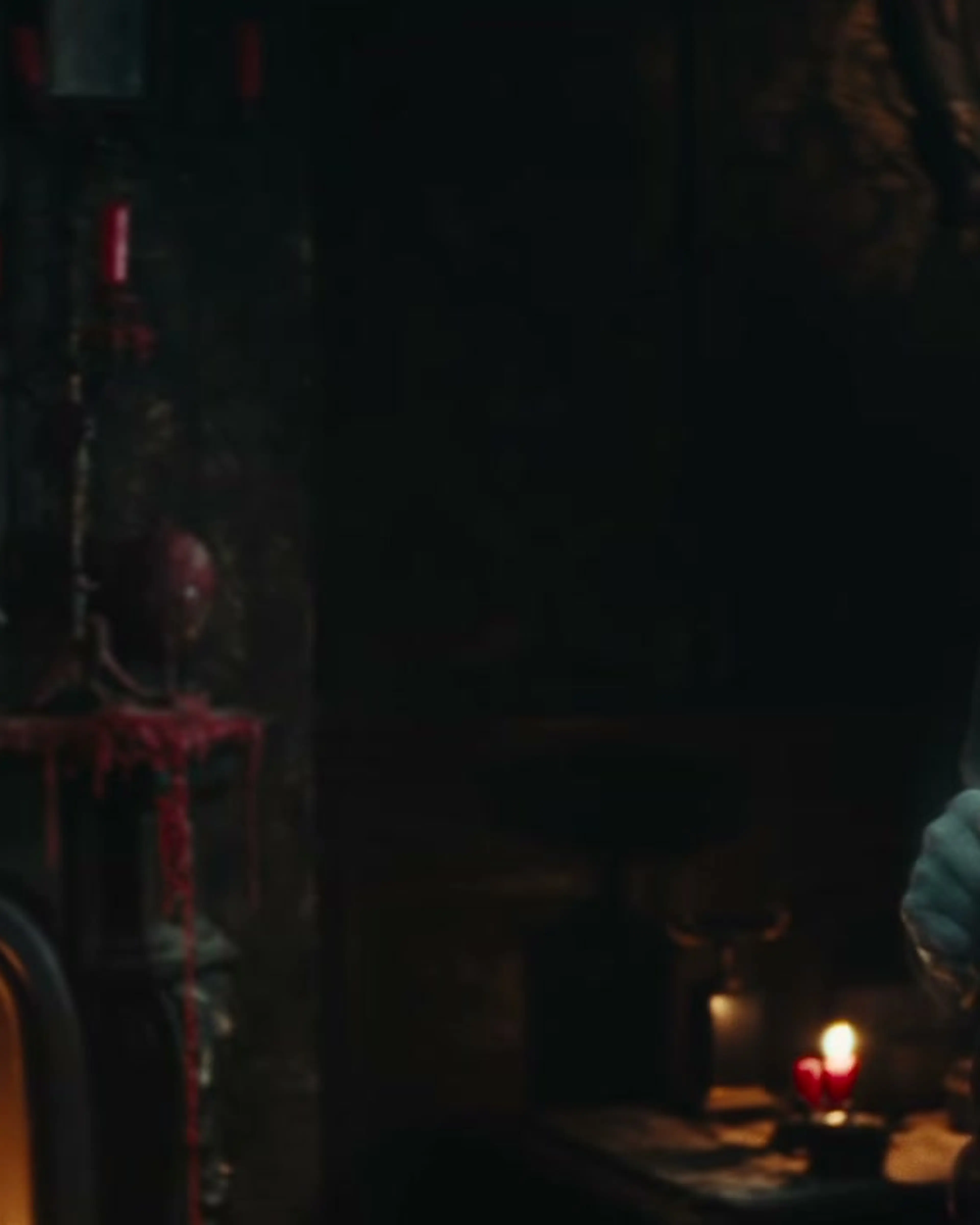Ian McKellen’s chained ghost faces Scrooge in a candlelit room.