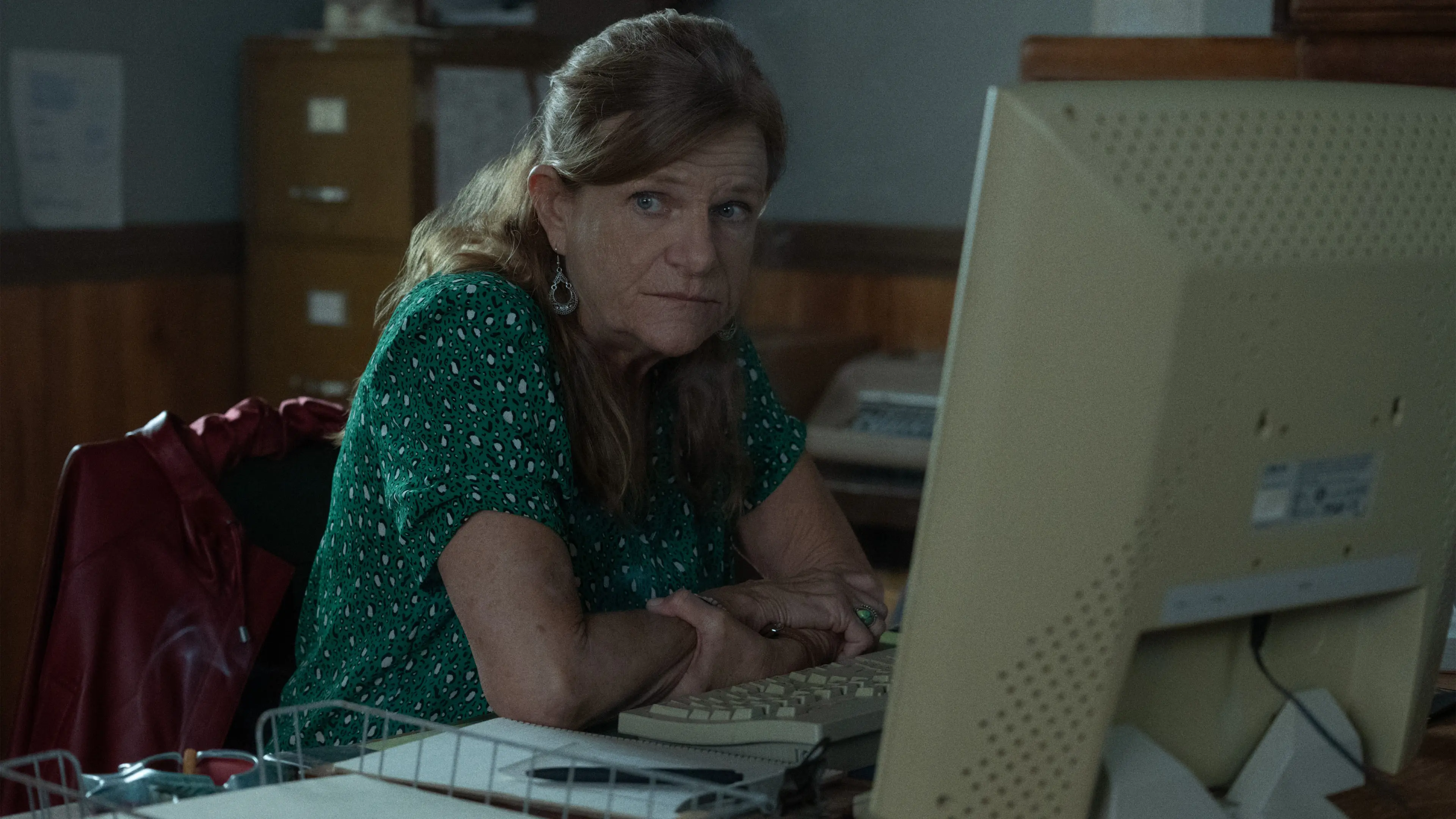 Dale Dickey sits at a computer in the town office in Widow’s Bay.