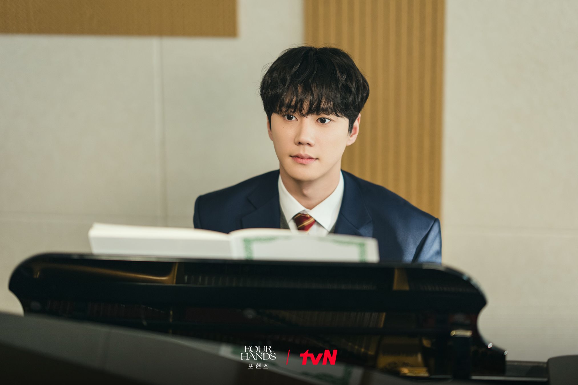 Lee Jun-young as Choi Jeong-yo stands in a music room in Four Hands, Two Sonatas.