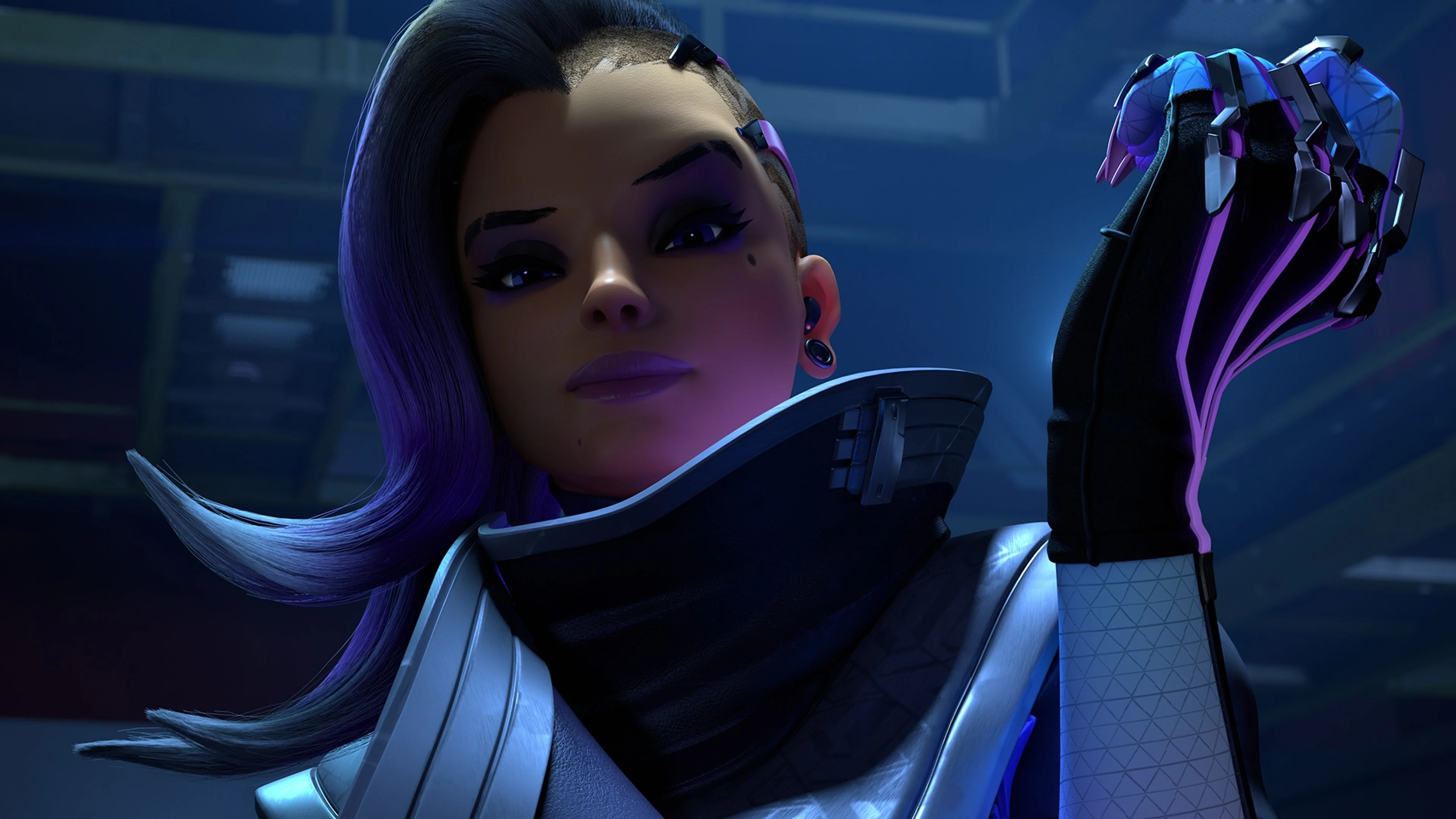 Sombra raises her cybernetic hand in a close view from Overwatch.