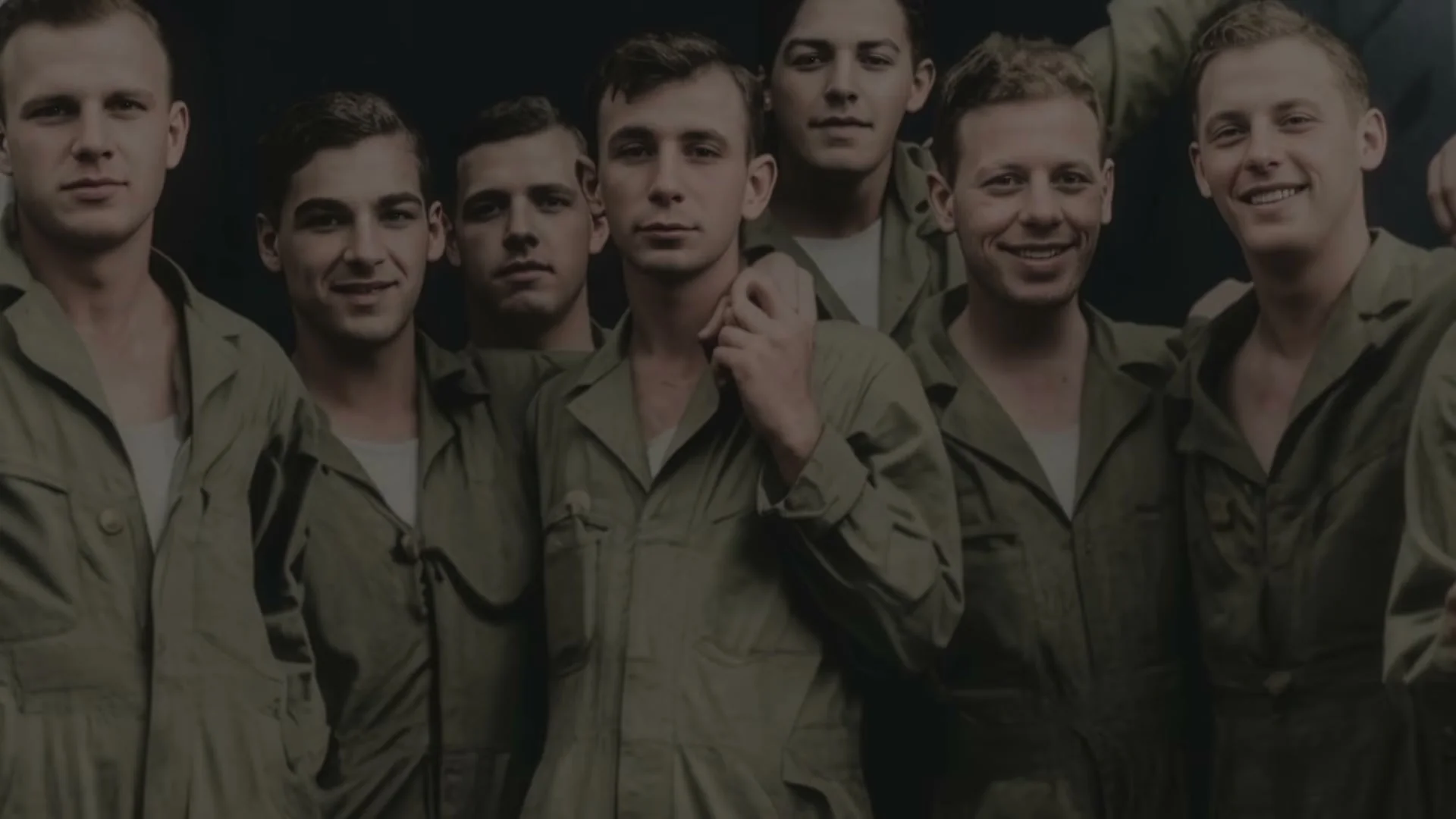 A group of young Band of Brothers cast members stand together in an archival image shown in the Legacy trailer.