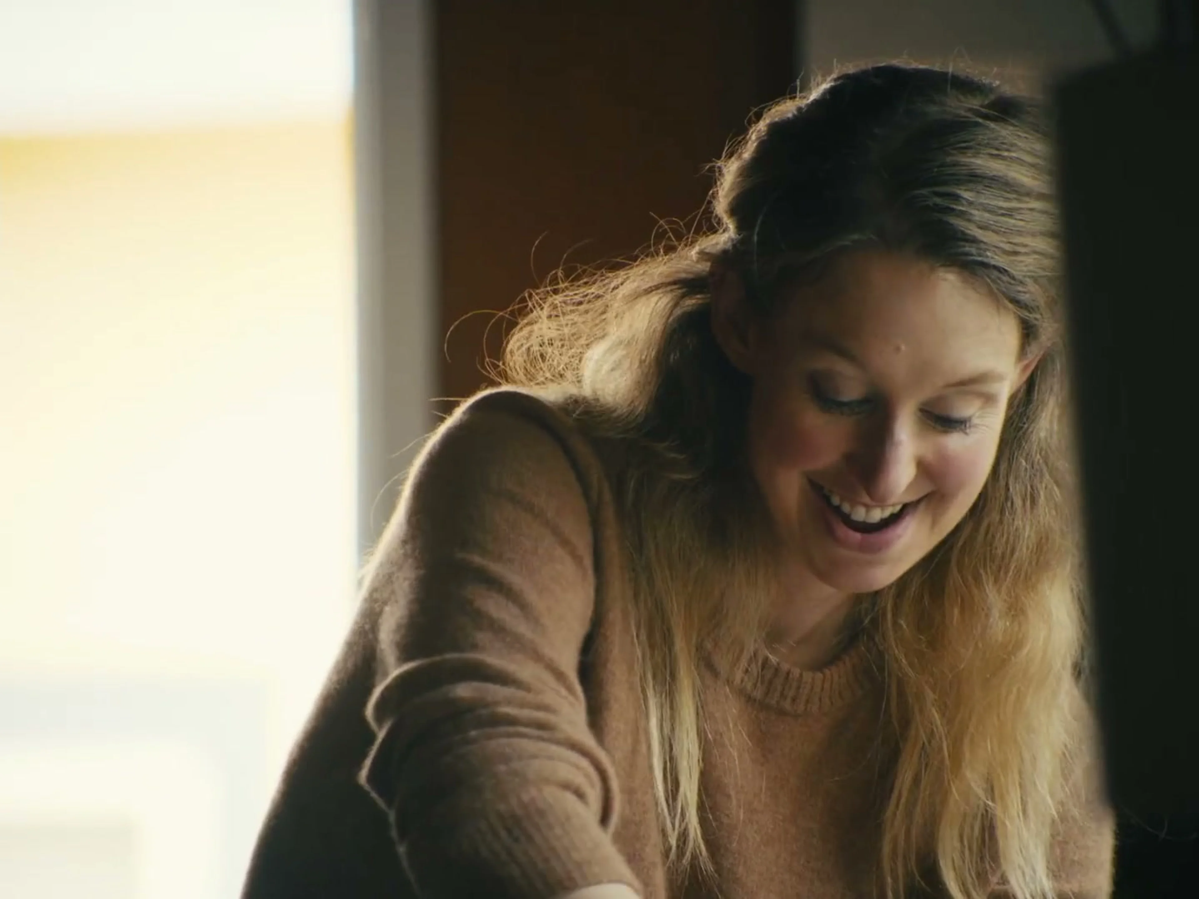 Elizabeth Holmes smiles during an interview scene in the official You Can See Everything trailer.