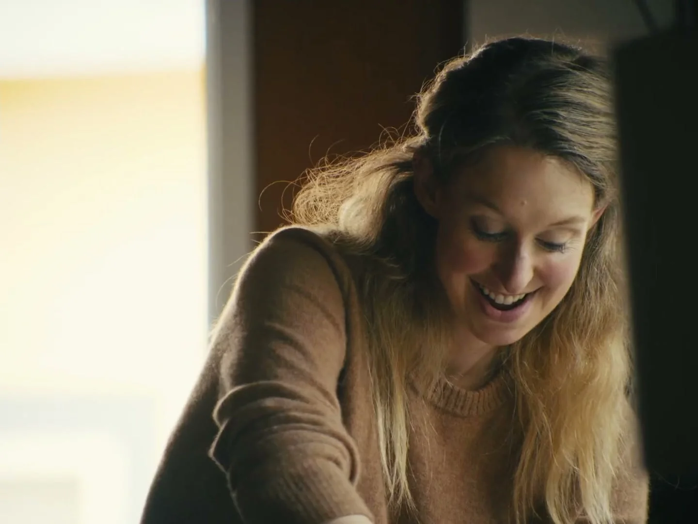 Elizabeth Holmes smiles during an interview scene in the official You Can See Everything trailer.