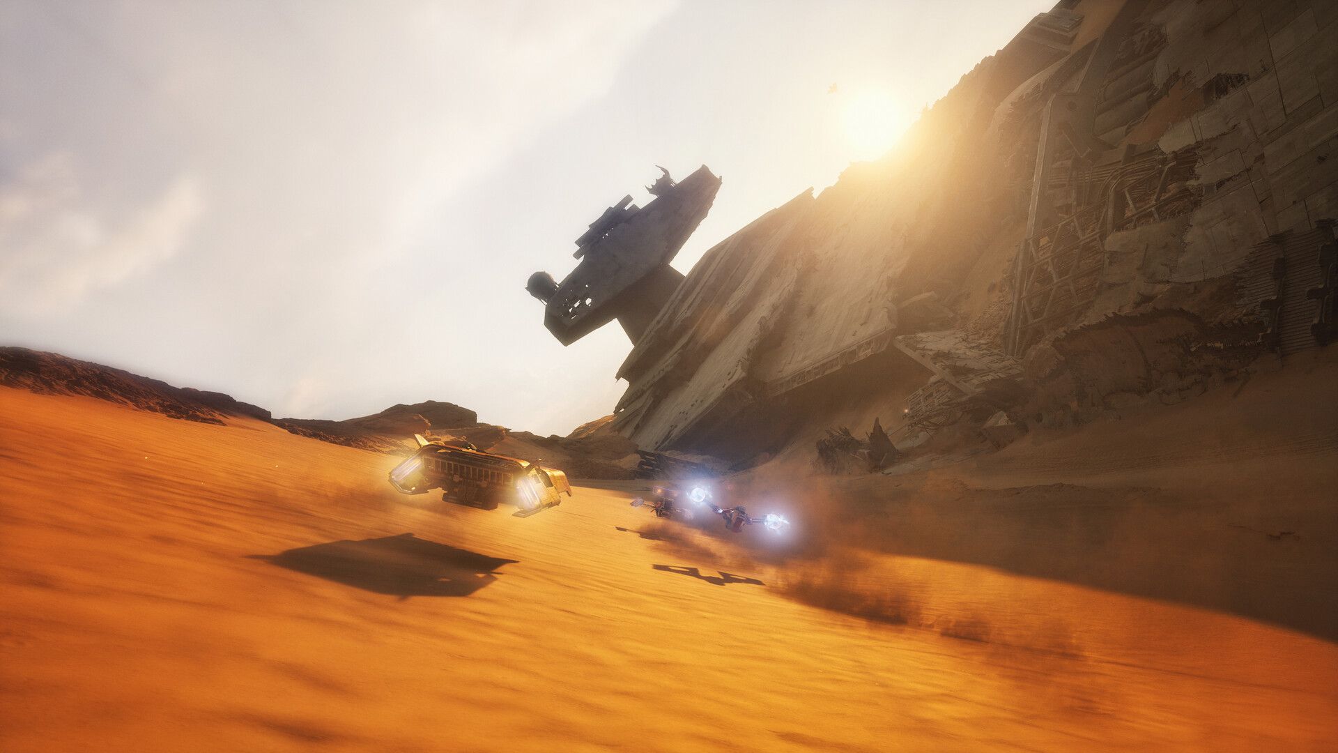 Sleek racers speed across orange dunes beneath a wrecked starship in STAR WARS: Galactic Racer.