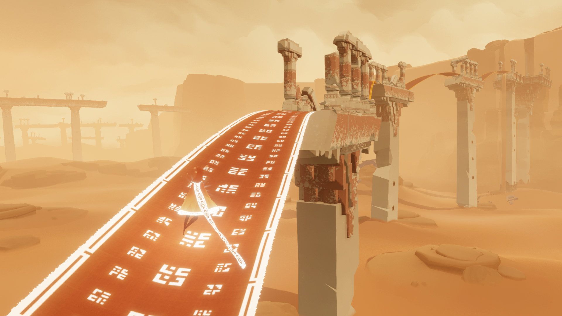 A robed traveler crosses a long cloth bridge between desert ruins.