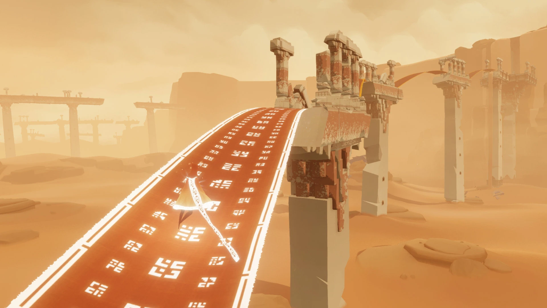 A robed traveler stands on a bright cloth bridge between desert ruins in Journey.
