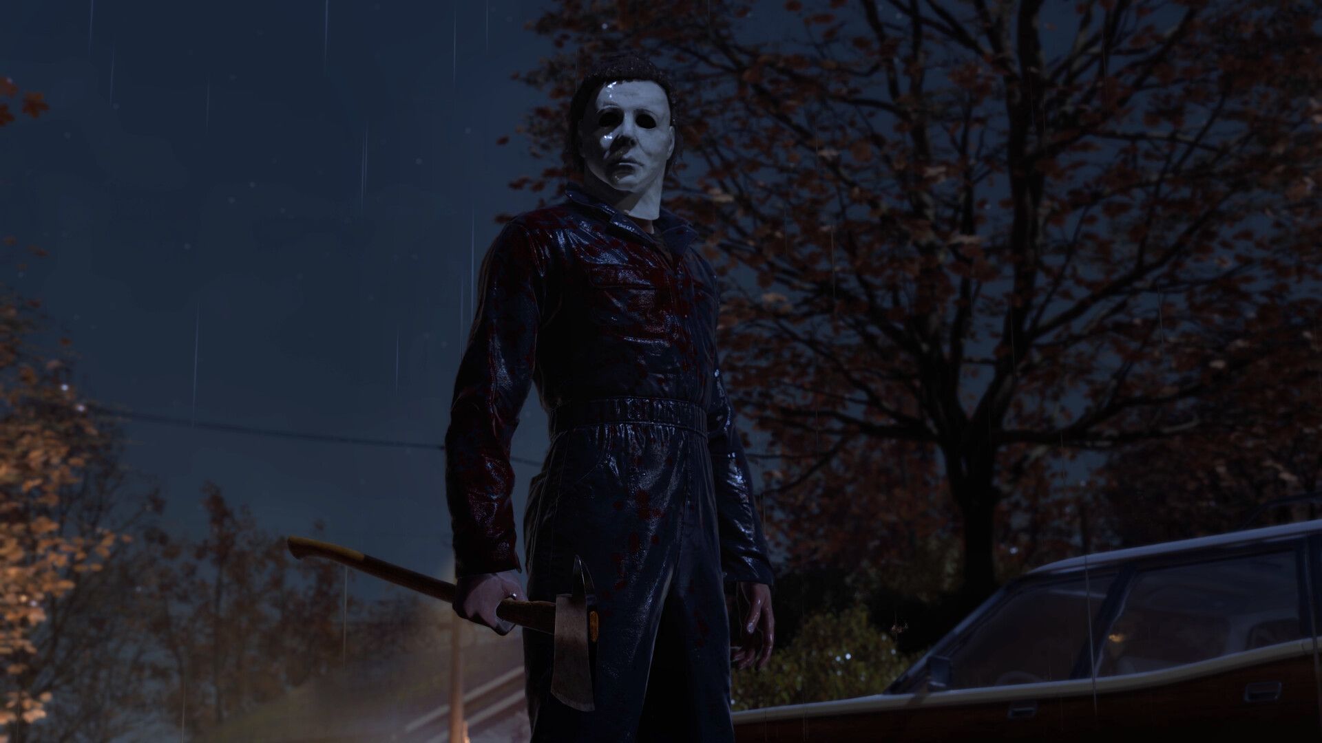Michael Myers holds an axe beside a parked car on a rainy Haddonfield street.
