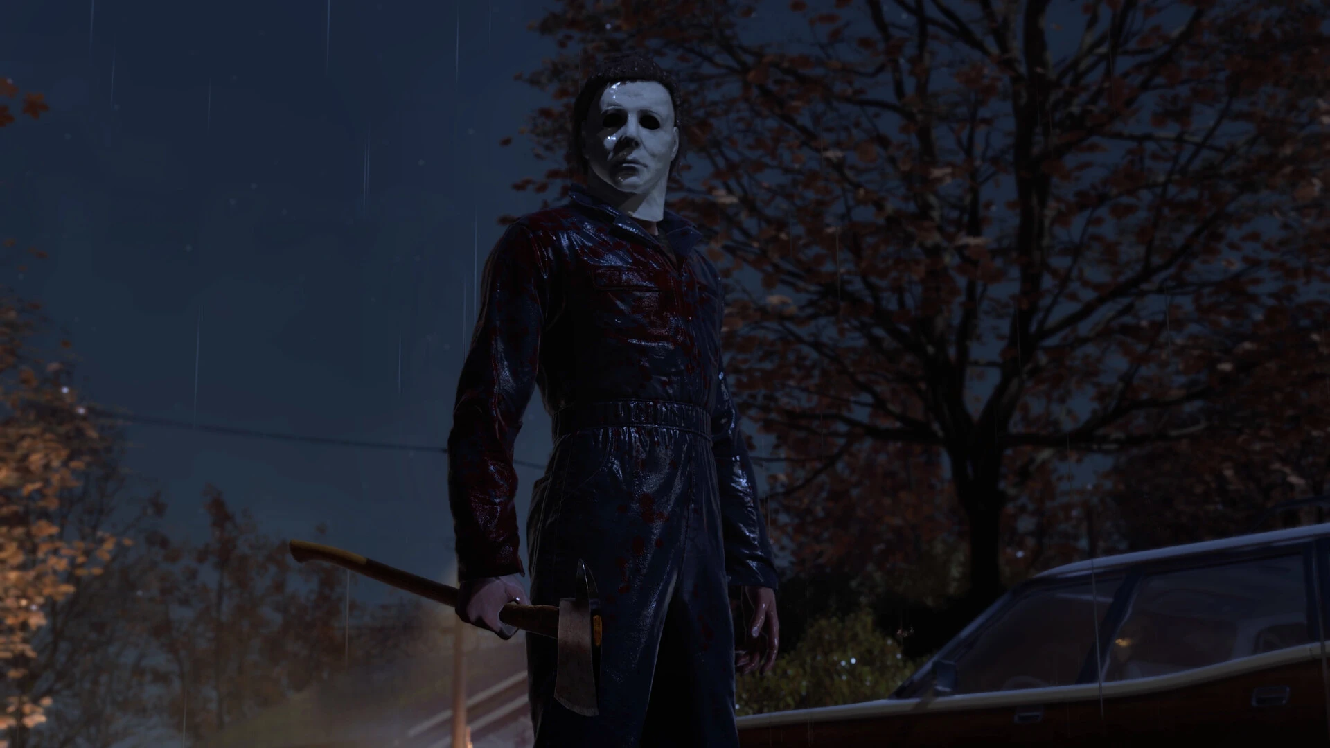 Michael Myers stands in the rain with a bloody axe beside a parked car in Halloween: The Game.