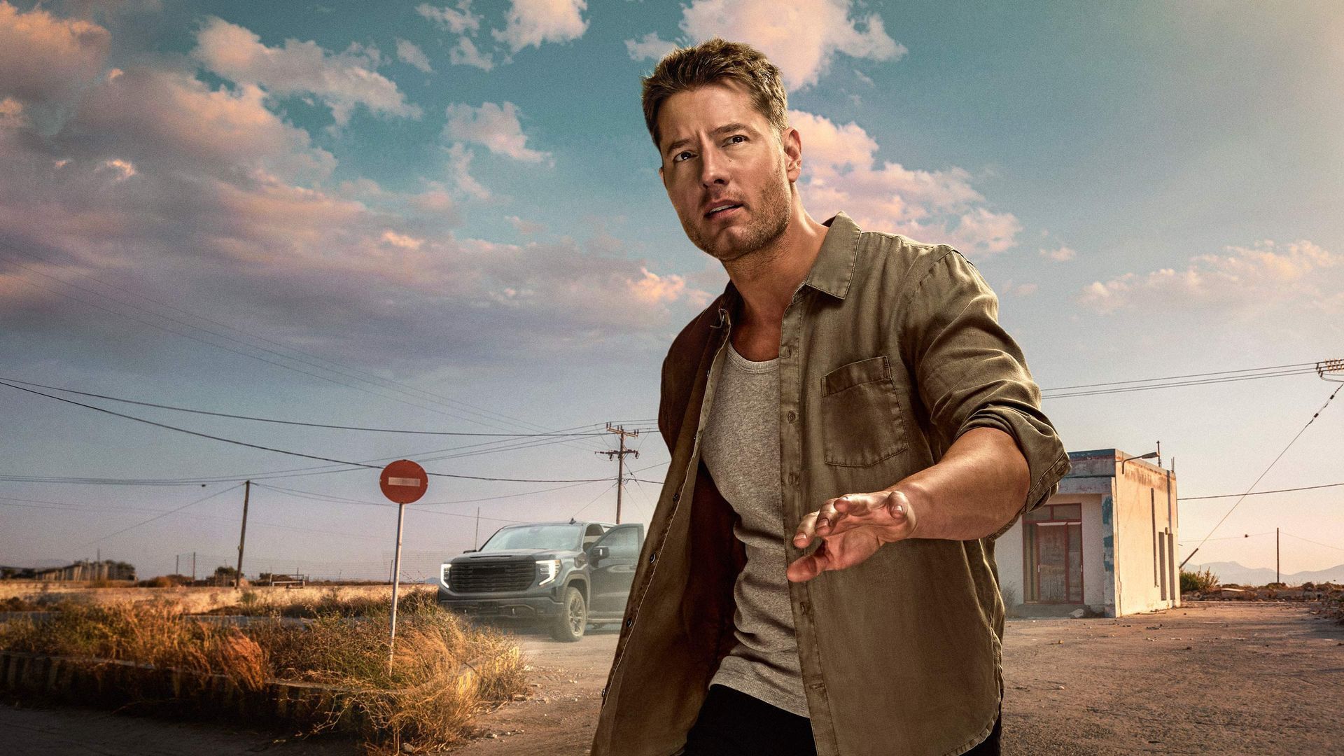 Justin Hartley stands beside a truck in official Tracker artwork.