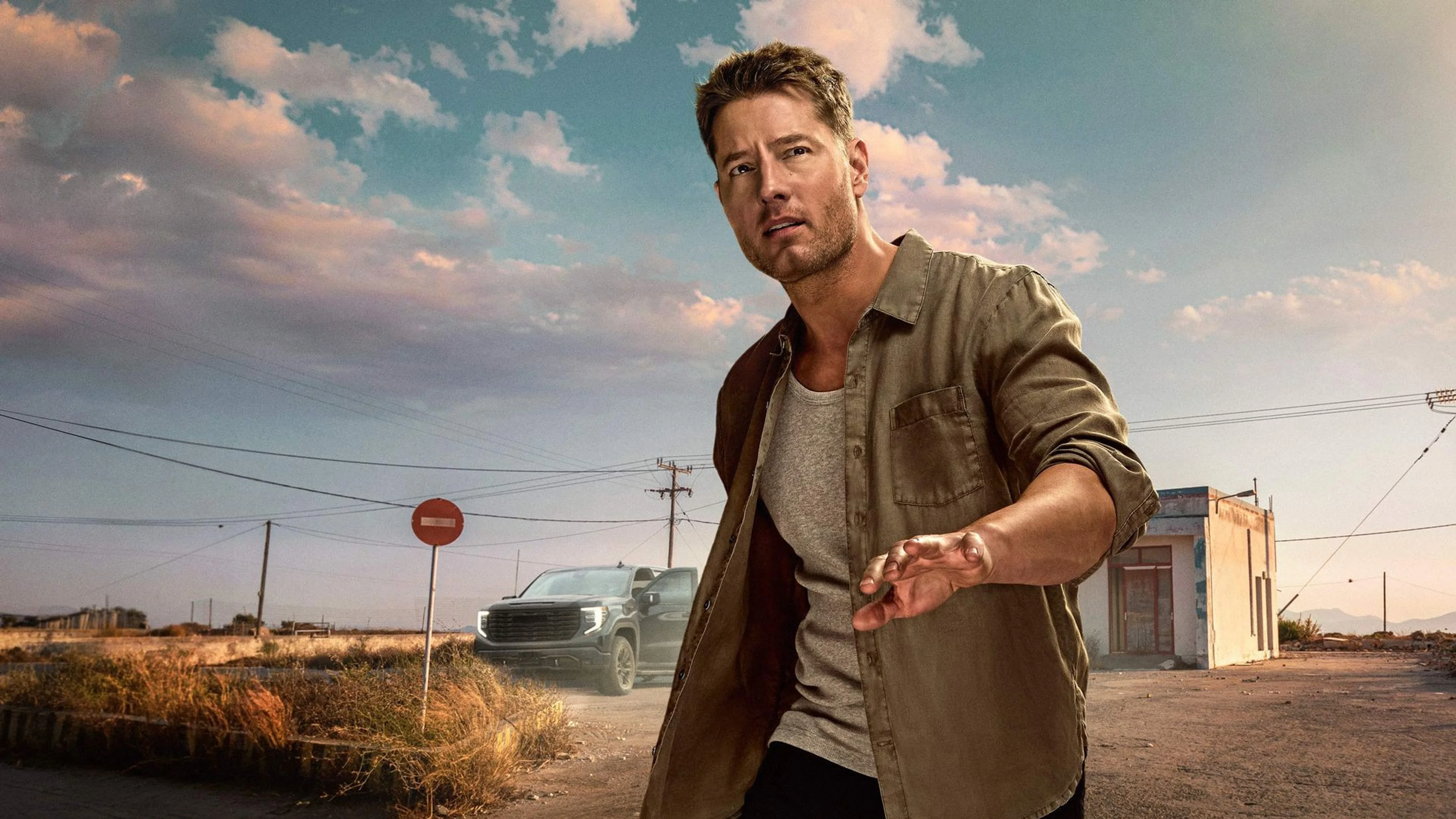 Justin Hartley stands beside a truck in official Tracker artwork.